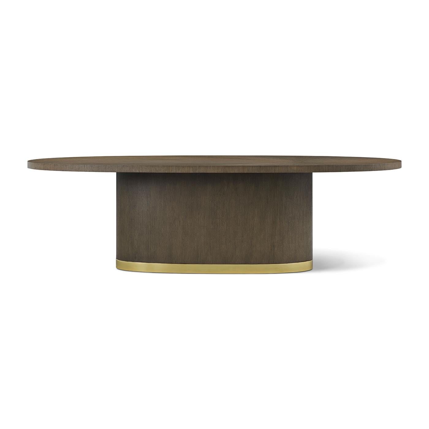 Un centre de table sophistiqué qui allie l'élégance sculpturale à un savoir-faire de haute couture. Présenté dans une riche finition Mink, le plateau ovale allongé présente un placage radial décentré de type sunburst, ponctué d'une incrustation