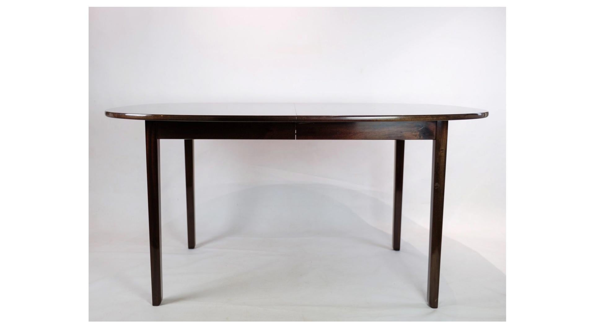 The mahogany dining table, designed by the renowned Ole Wanscher and produced by P. Jeppesen in 1960, represents an elegant and timeless piece of Danish furniture design.

The mahogany wood used in the table adds a classy and warm atmosphere to any