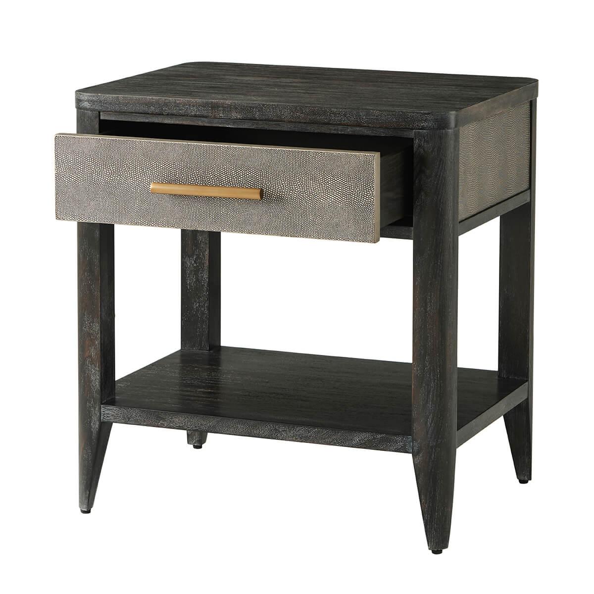 In the rowan finish with Komodo embossed leather sides. The rectangular bedside table has a soft-closing single drawer with a brushed brass handle, curbed corners and a lower shelf stretcher base.

Dimensions: 23.5