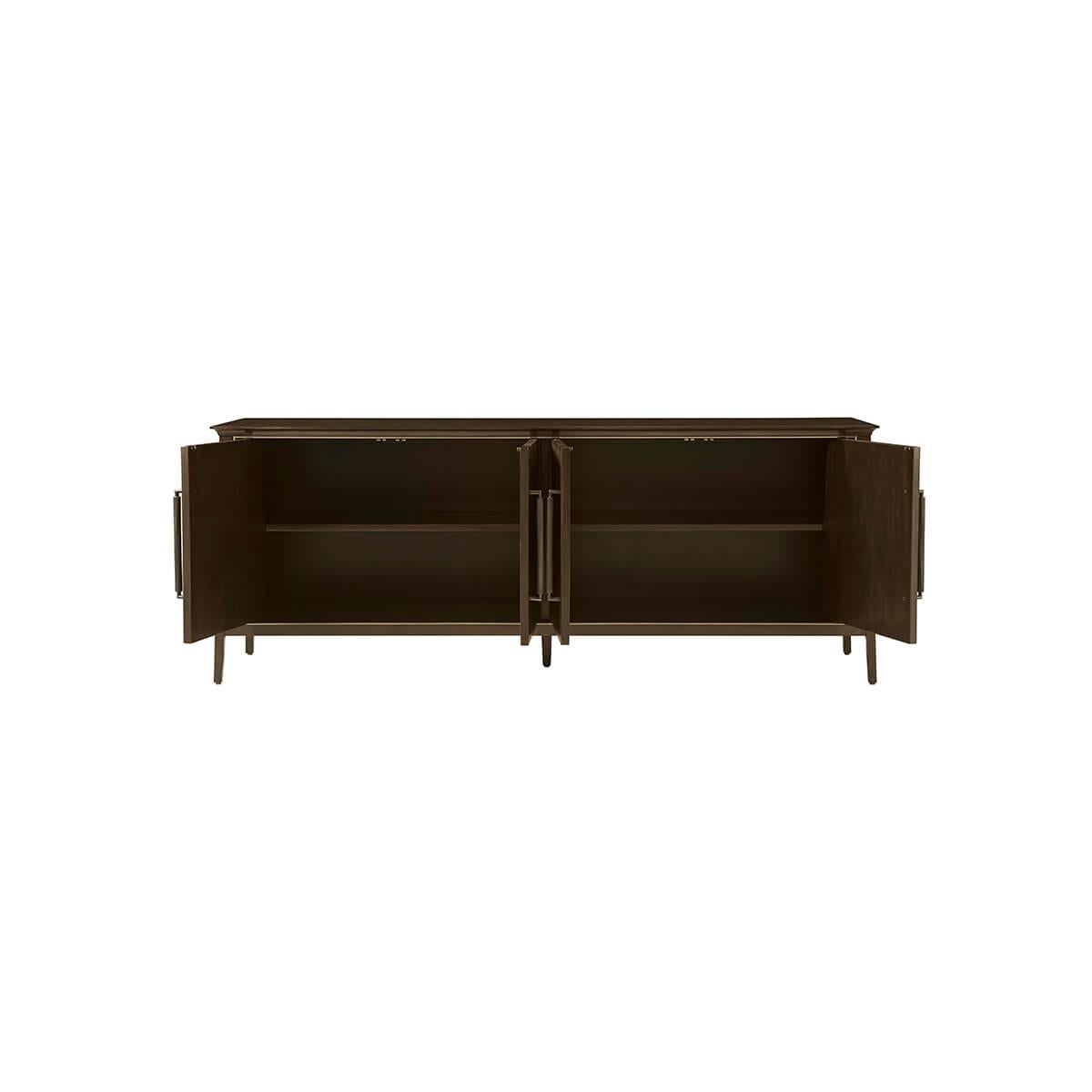 Mid Century Credenza, features a sophisticated tapering silhouette and reeded angular doors, crafted from Prima Vera in our Bistre finish. The custom forged hardware, finished in a dark rubbed bronze, echoes the reeded details