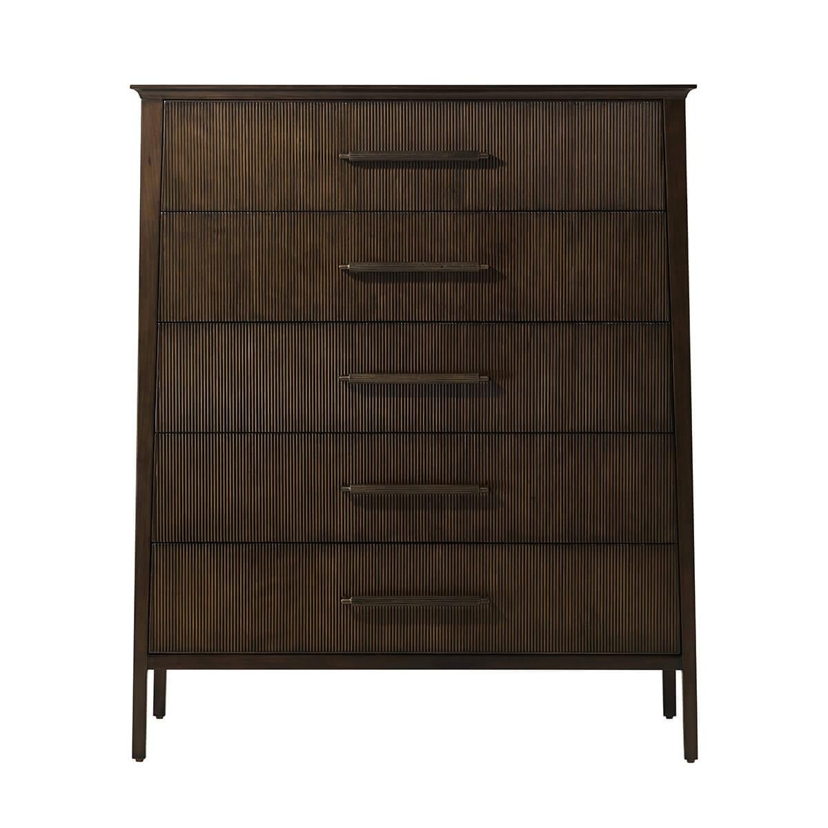 Featuring a sophisticated tapered silhouette with five reeded drawer fronts. The custom forged hardware, finished in a dark rubbed bronze, echoes the reeded details throughout.

Dimensions: 42.25