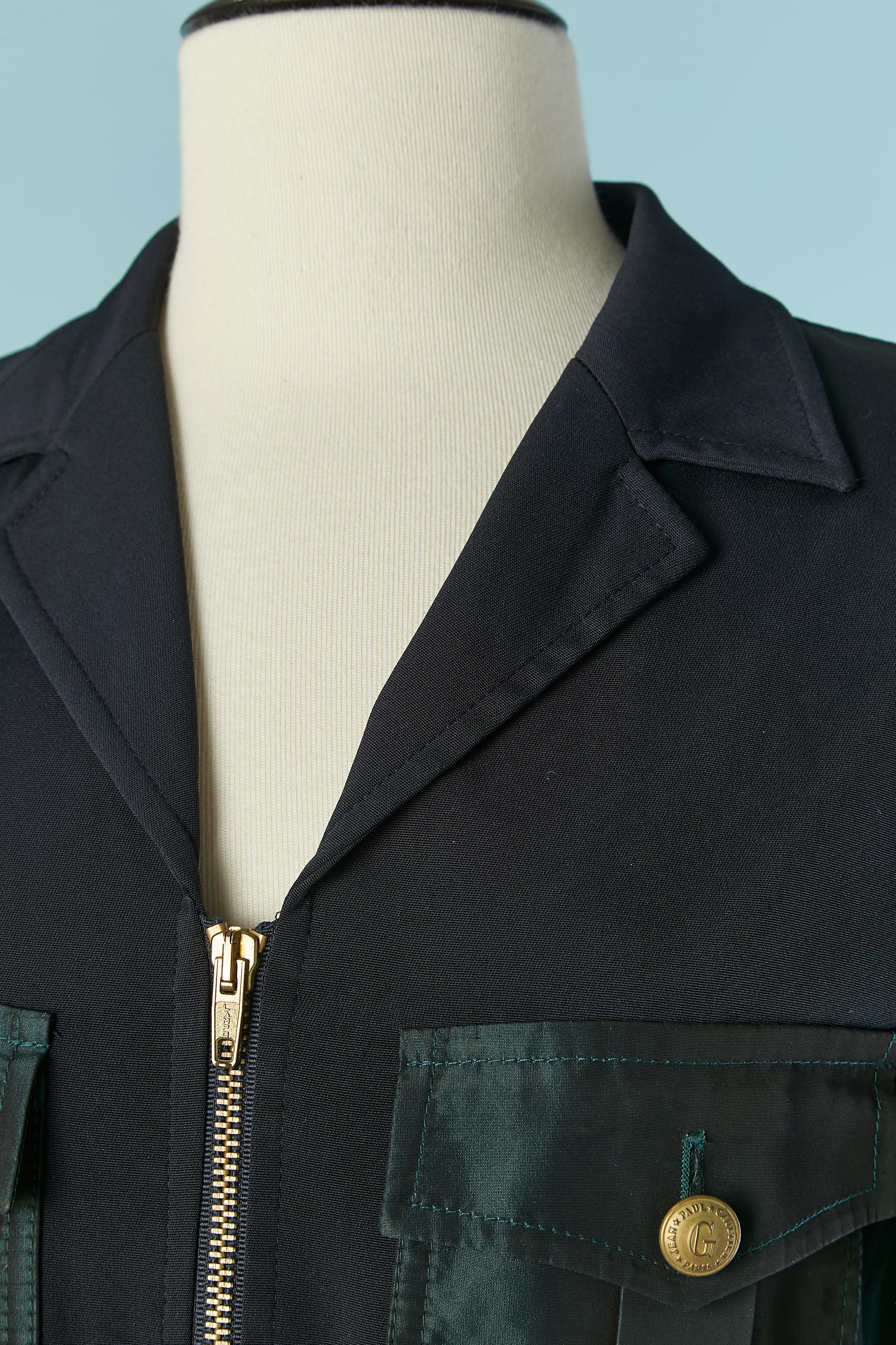 Dark navy blue and green taffetas trouser suit . 1st Fabric composition ( navy blue) : 73% acetate, 18% polyamide, 9% elastane. 2nd fabric ( green) 77% acetate, 23% polyester. 
Zip closure on the middle front. Branded button and buttonhole closure