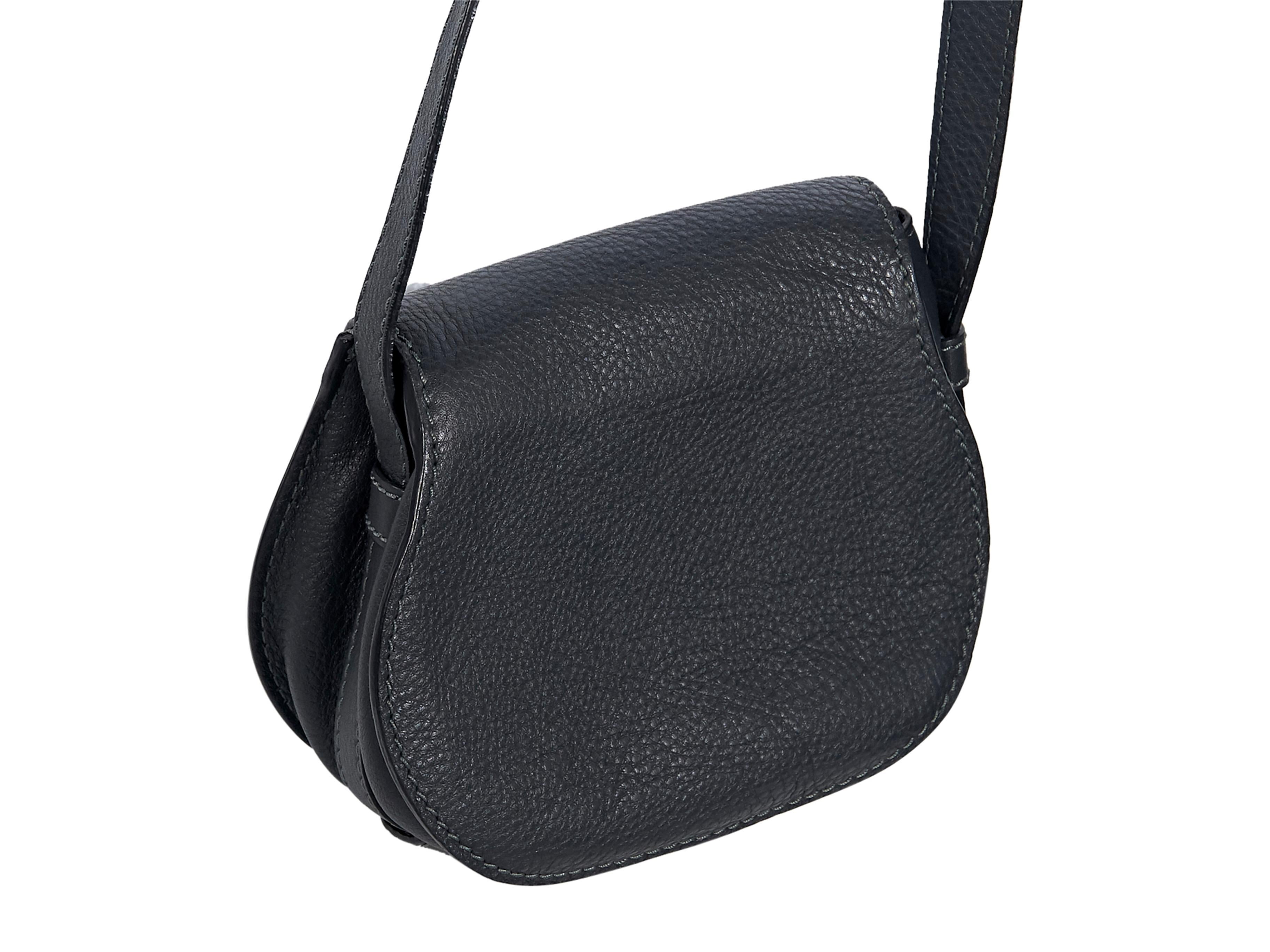 Product details:  Dark navy blue leather Marcie saddle bag by Chloe.  Adjustable crossbody strap.  Front flap with toggle tab closure.  Lined interior with inner slide pocket.  Goldtone hardware.  6.5