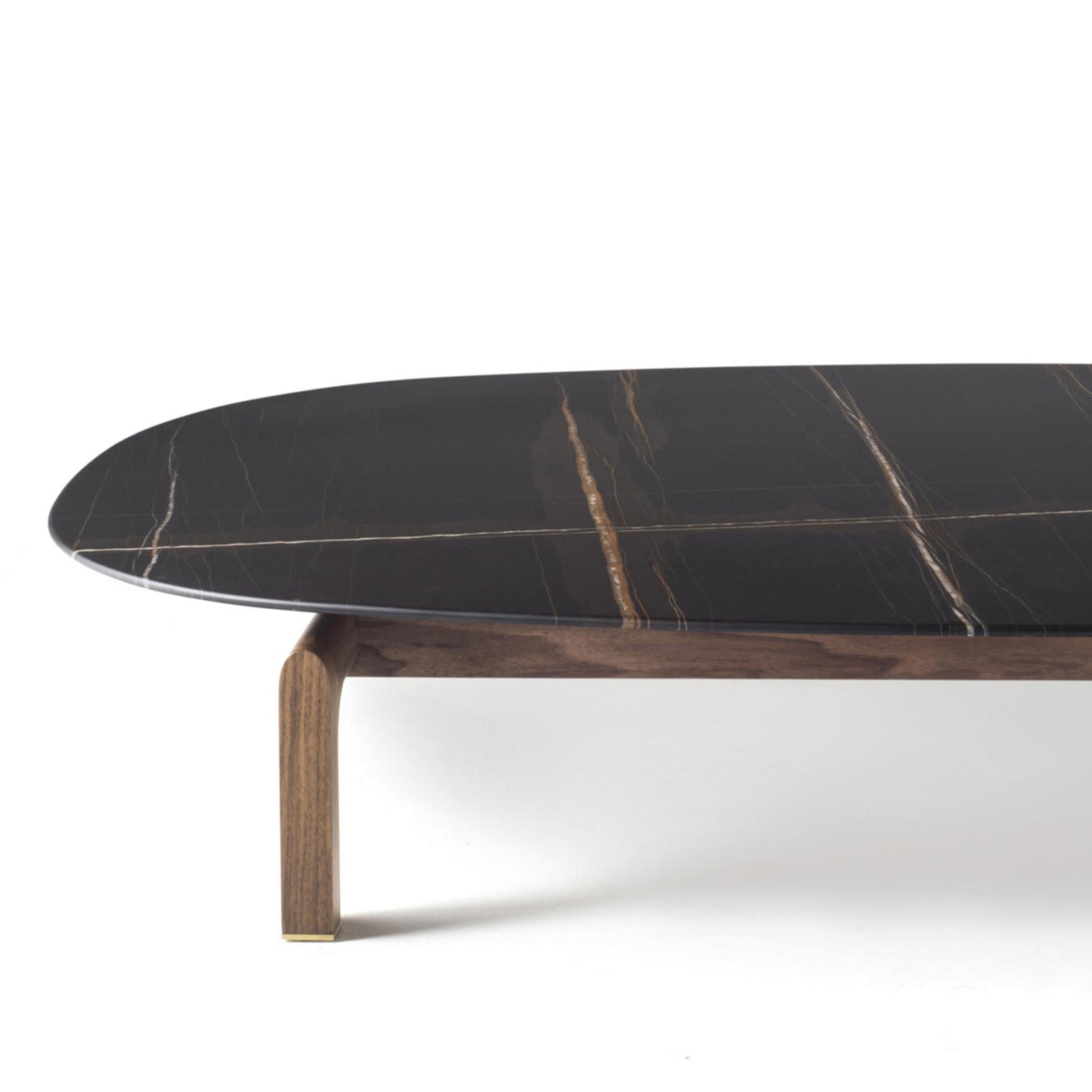 Coffee table dark night with black Sahara marble
high quality and with handcrafted solid walnut
wood base.
Also available with white Calacatta marble top
or emperador marble top, on request.
Also available with rectangular top.
