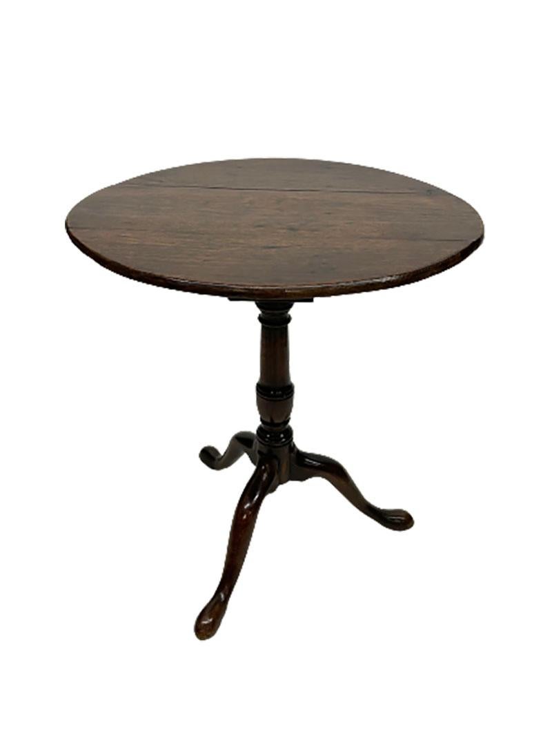 Dark oak 18th century tilt-top tripod table.

A round with beautiful patina oak wooden tripod tilt-top table.
A late 18th Century table and measures 60 cm diagonal.
The table top is attached via a wooden pin, which is firmly pushed in. The