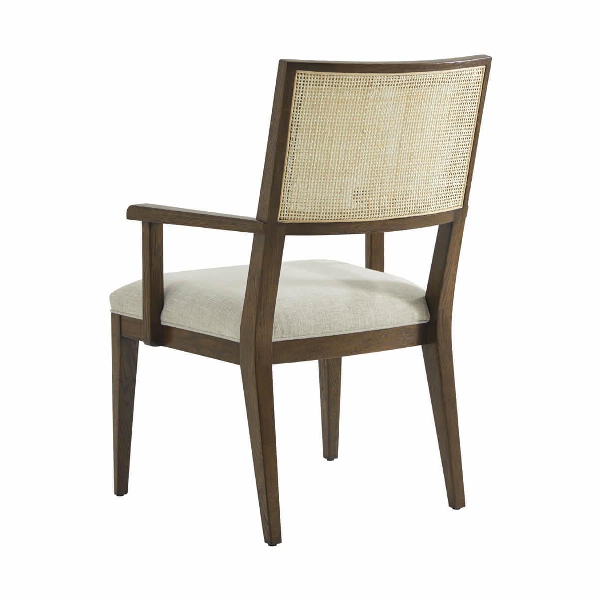 Dining Arm Chair, a solid frame in our dark Earth finish, with a curved and caned backrest, a padded and upholstered seat cushions raised on tapered legs.

Dimensions: 24