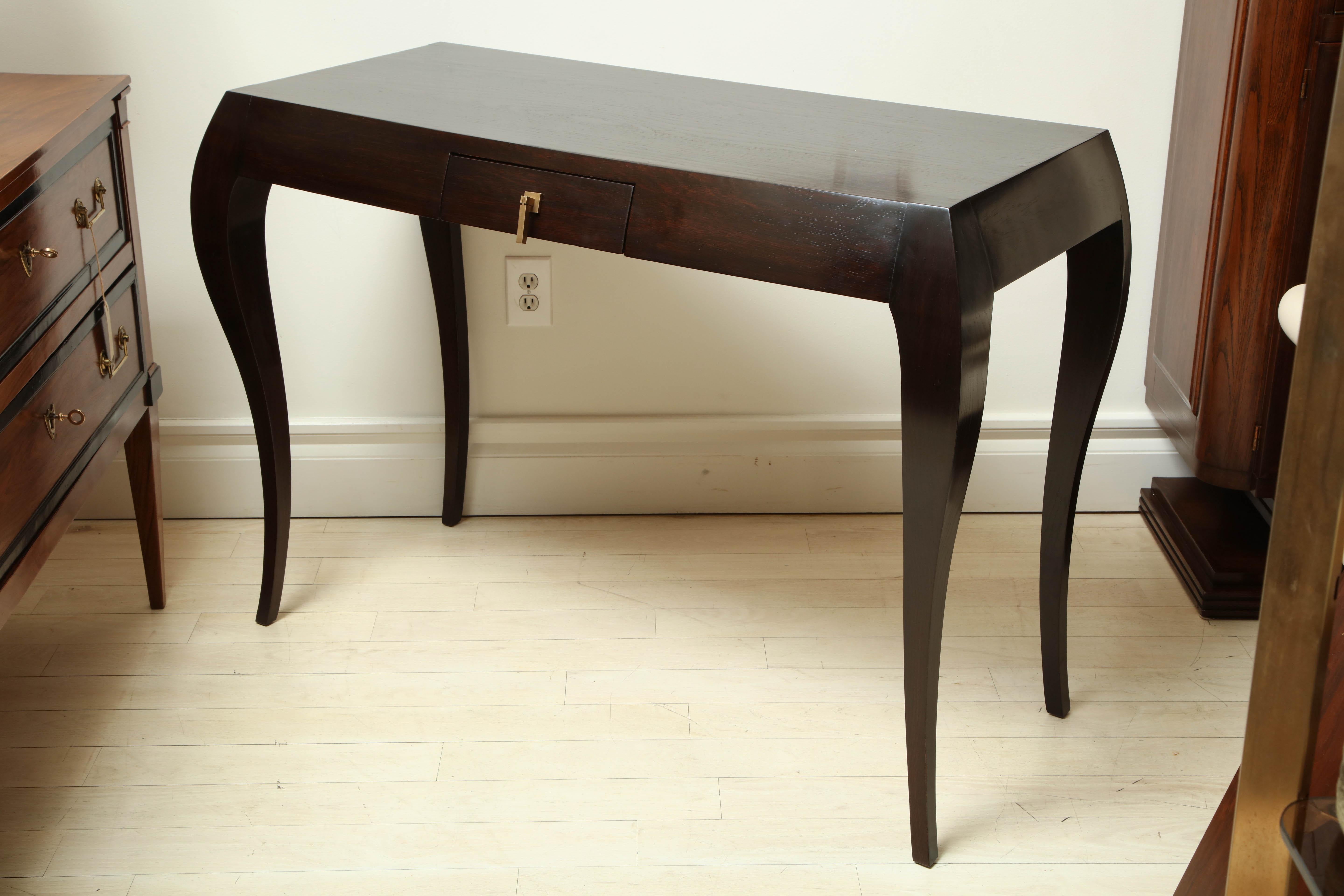 Large, dark stained oak console table, the rectangular top with small frieze drawer and brass pull. All four legs are curved, the rear legs with a flat profile. France, circa 1960.