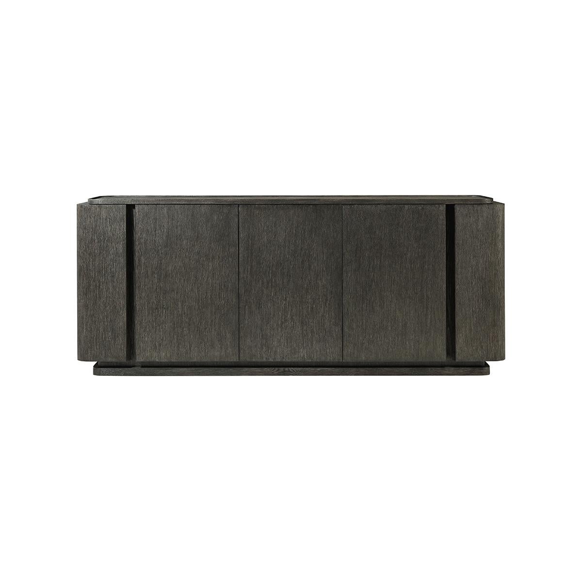 A hand-rubbed charcoal oak finish. Handcrafted from solid wood, the multistep, hand-finishing process on this 78-inch triple door sideboard creates a beautiful brushed-like effect that enhances the natural grain variation of the Oak Vaneer.

Hidden