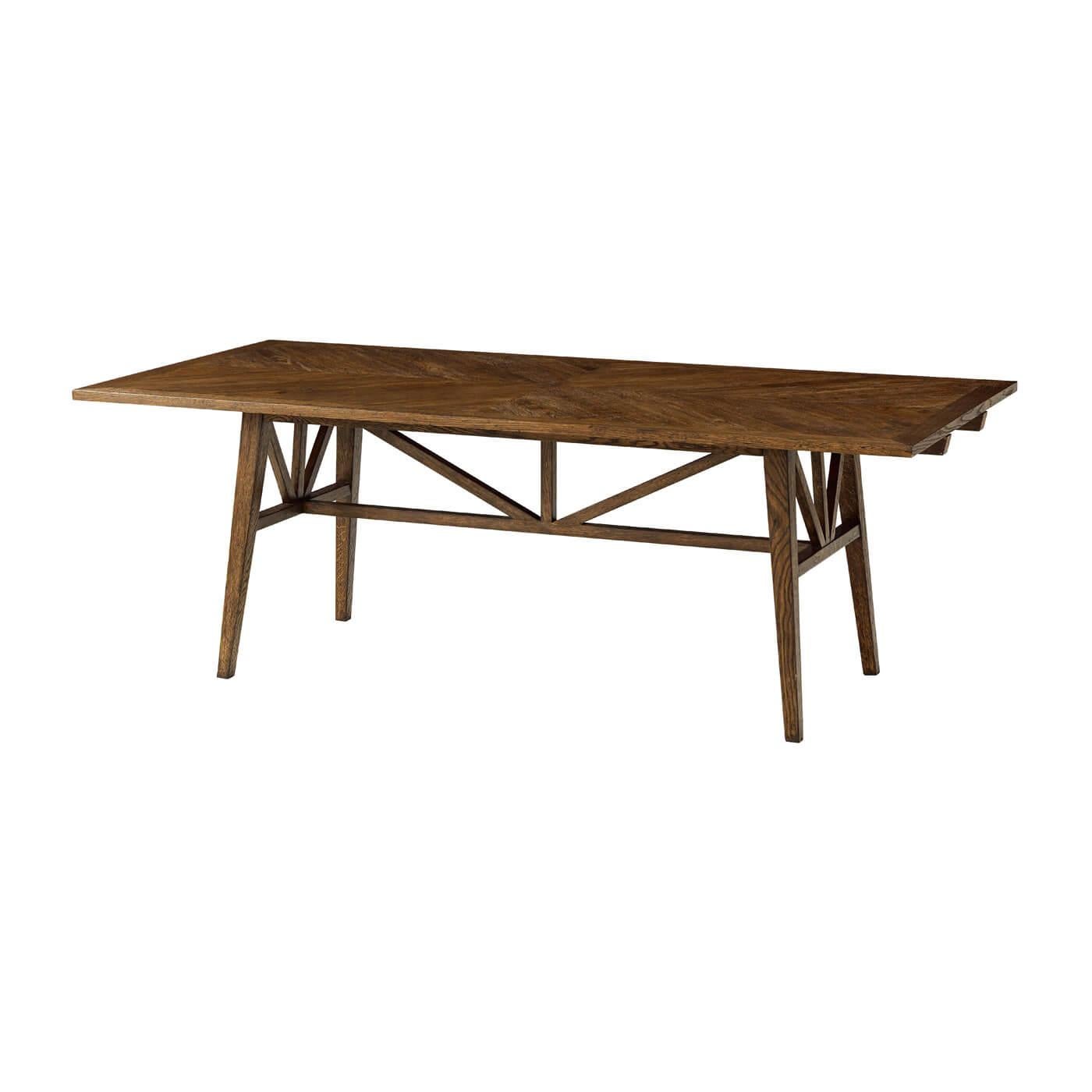 A dark oak parquetry extending dining table with finely tapered oak legs. This beautiful table is crafted from rustic oak with a herringbone parquetry design. It offers two extension leaves and over a flat truss. 
Shown in Dusk