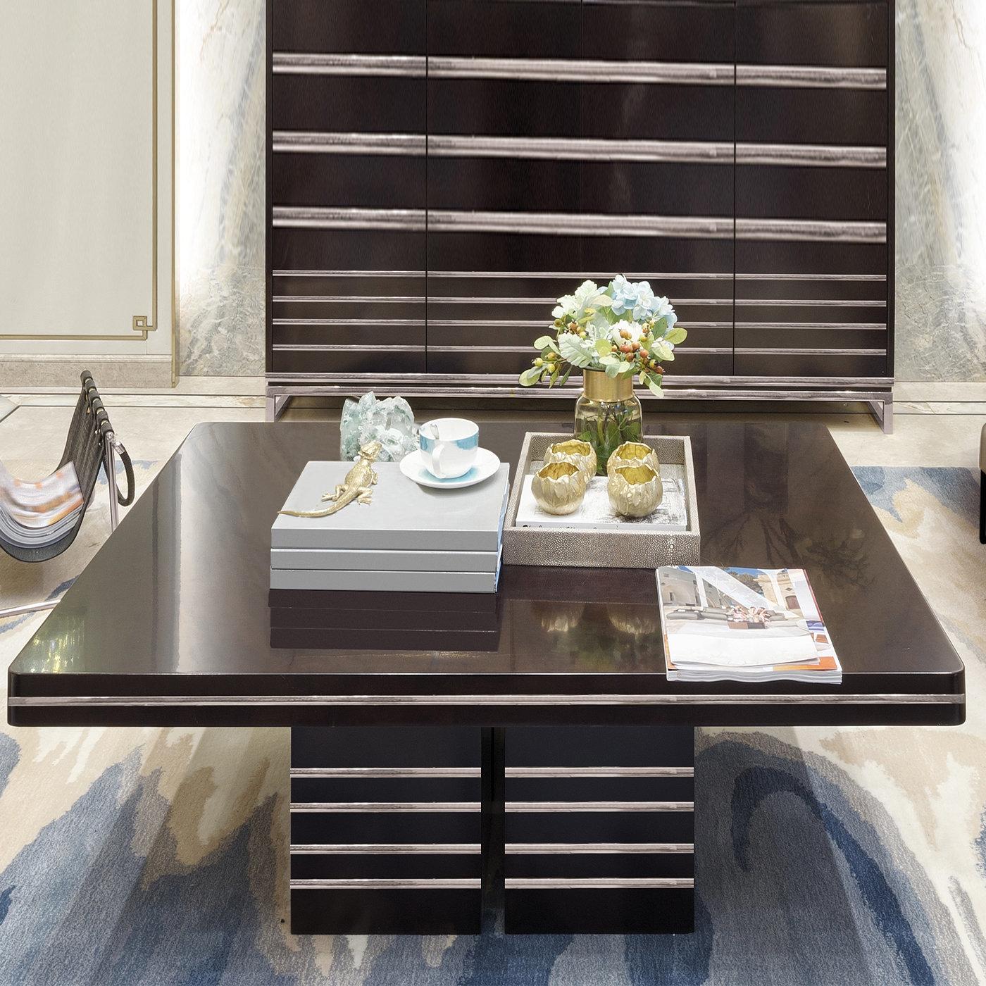 This stunning coffee table veneered in dark walnut oak perfectly embodies mid-century style. Its streamlined silhouette - combining a sturdy blockboard structure with glossy horizontal bands in bronzed metal accenting the base and the top's edges -