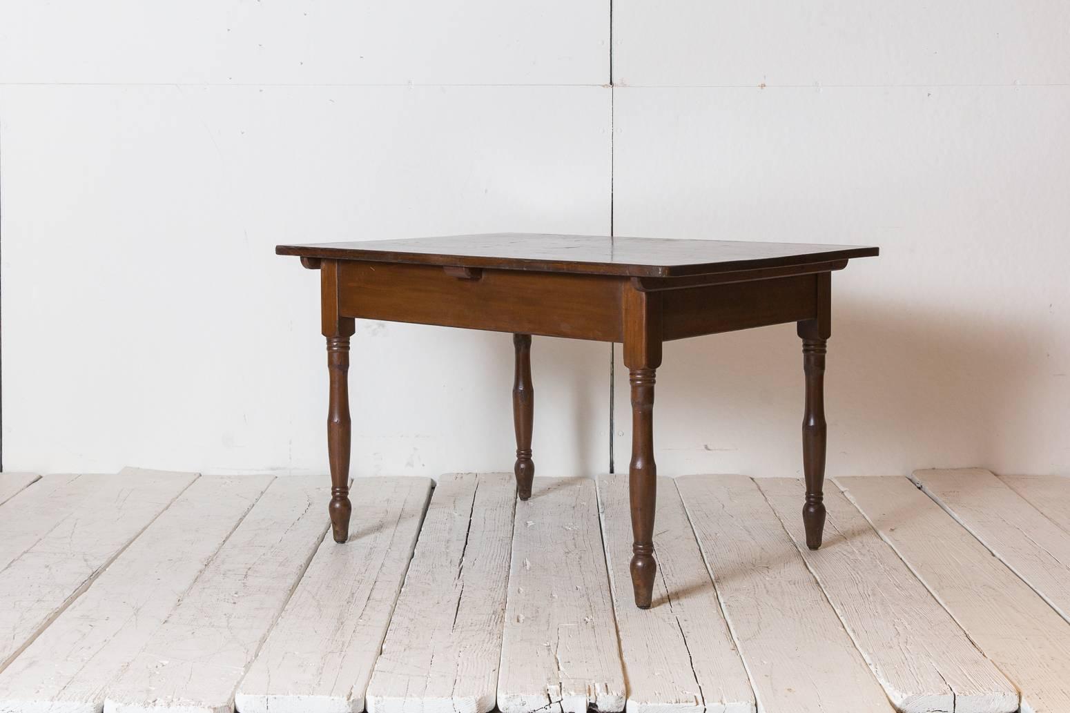 Dark oak stained rectangular farm table with turned legs.