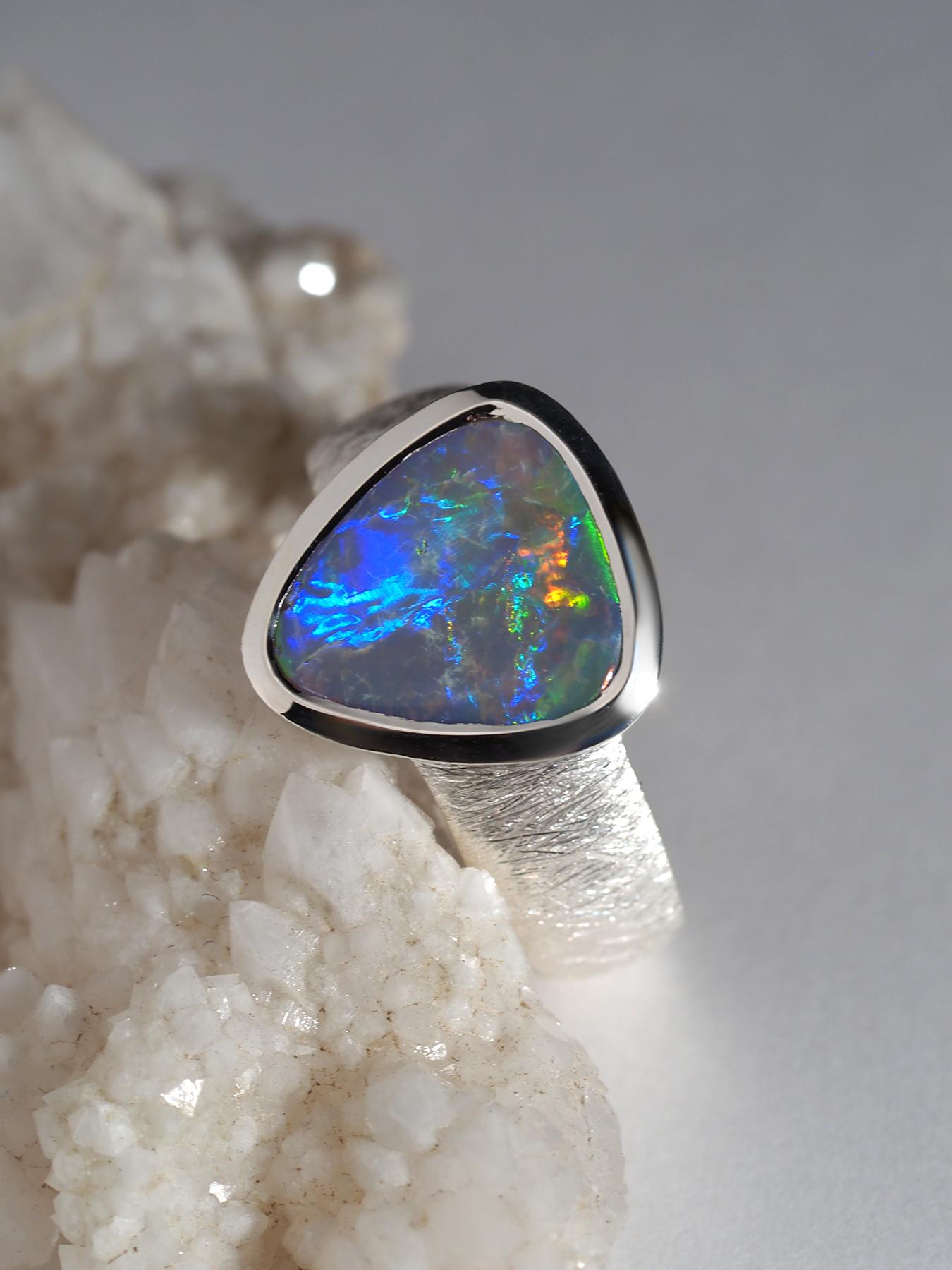 Silver ring with natural vivid Dark Opal with Violet, Purple, Orange, Green, Yellow and Red opalescence 
Opal origin - Australia
weight of the Opal - 2 carat
gemstone measurements  10 х 12 mm
ring weight - 6.5 grams
ring size - 8 US, diameter 18.25