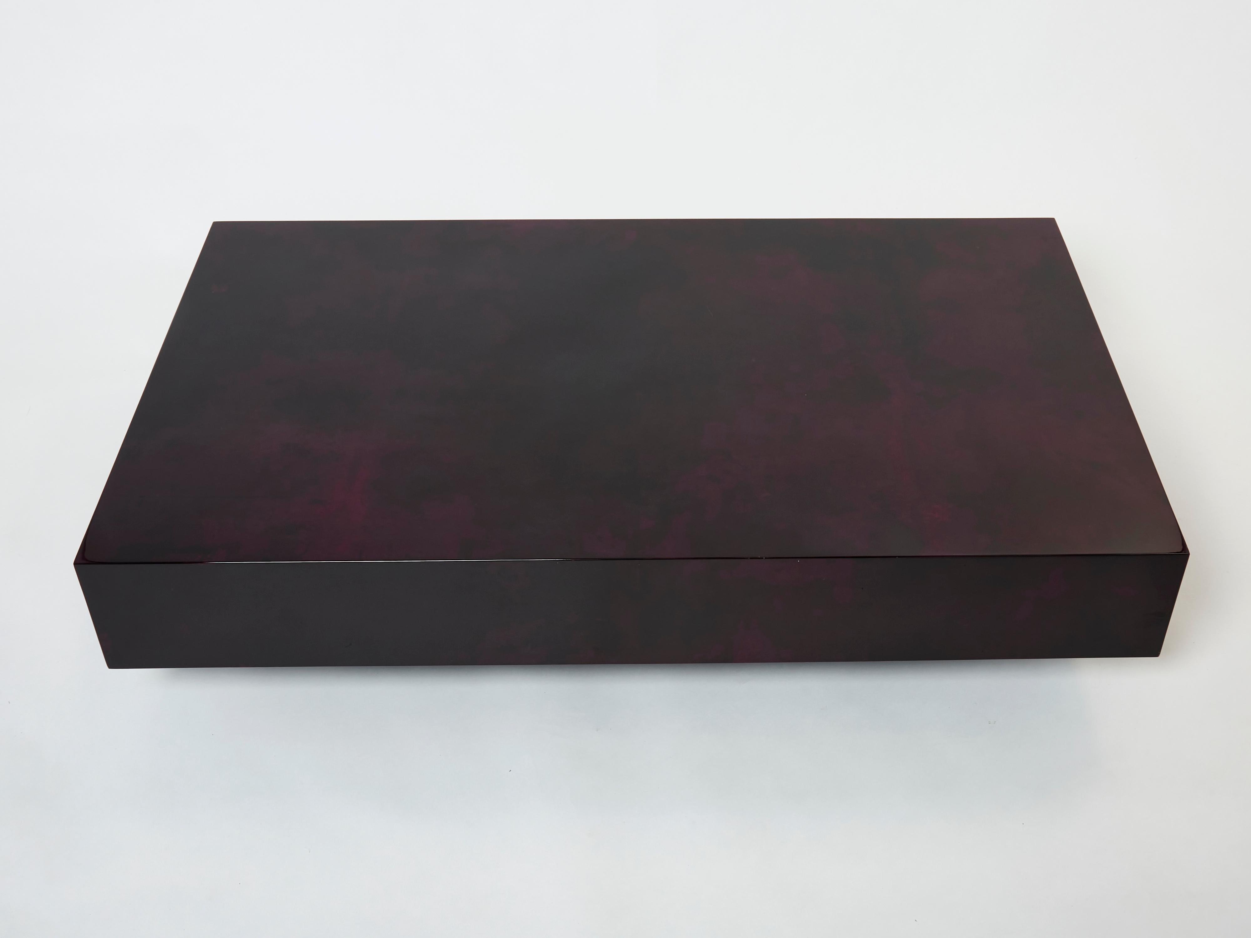 This glossy varnished goatskin parchment, in rich shades of purple and dark purple, makes this beautiful coffee table typical of designer Aldo Tura. It was made in Italy in the late 1960s. This large coffee table would make a fascinating centerpiece