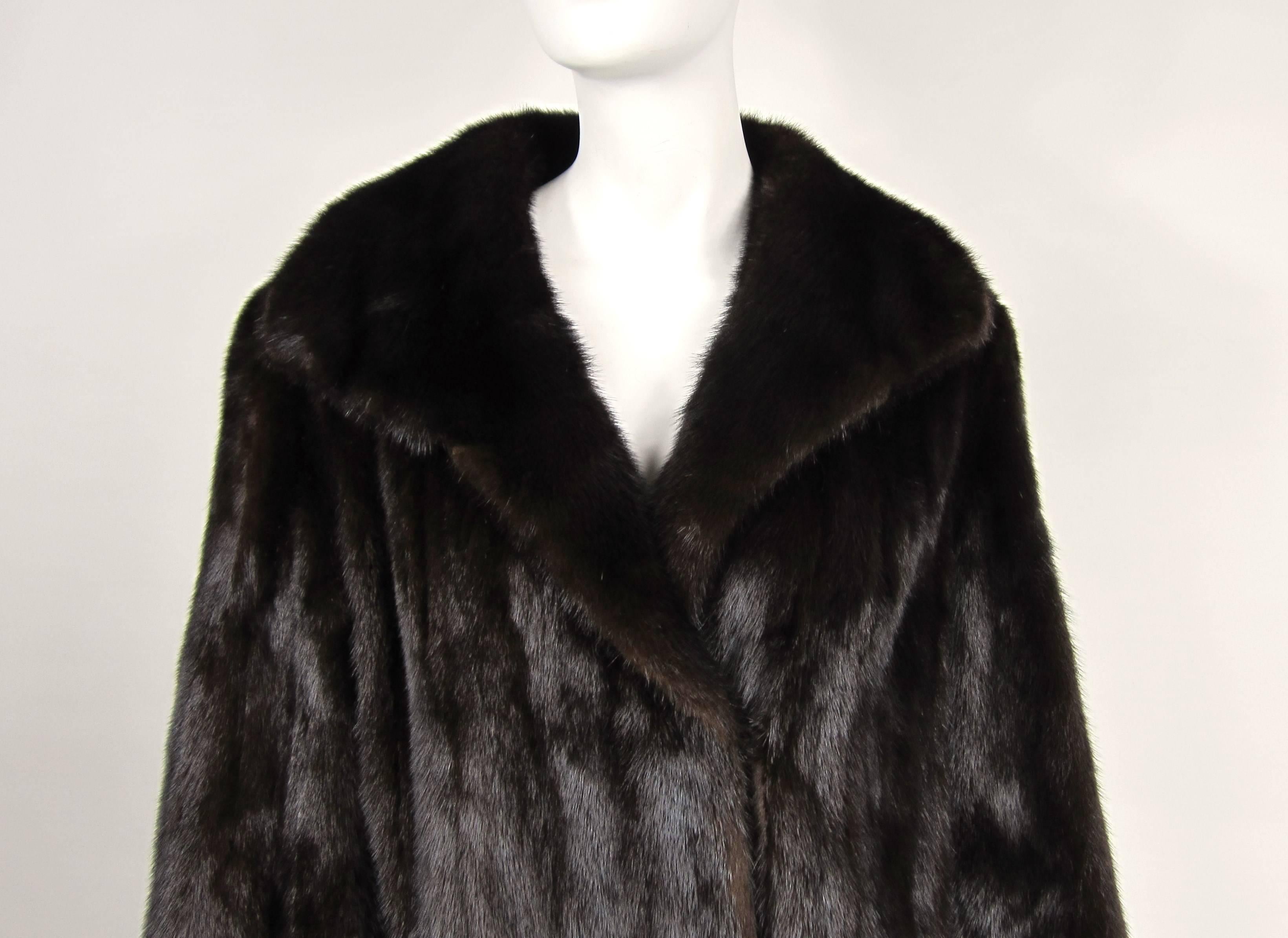 Stunning Classic Mink Coat. Straight cut, timeless. Soft and supple. Very Deep color on this one. Velvet lined pockets with a 2 clip closure. This is not monogrammed. Measurements up to 40-inch chest, up to 42-inch waist, up to 48-inch hips, 23-inch