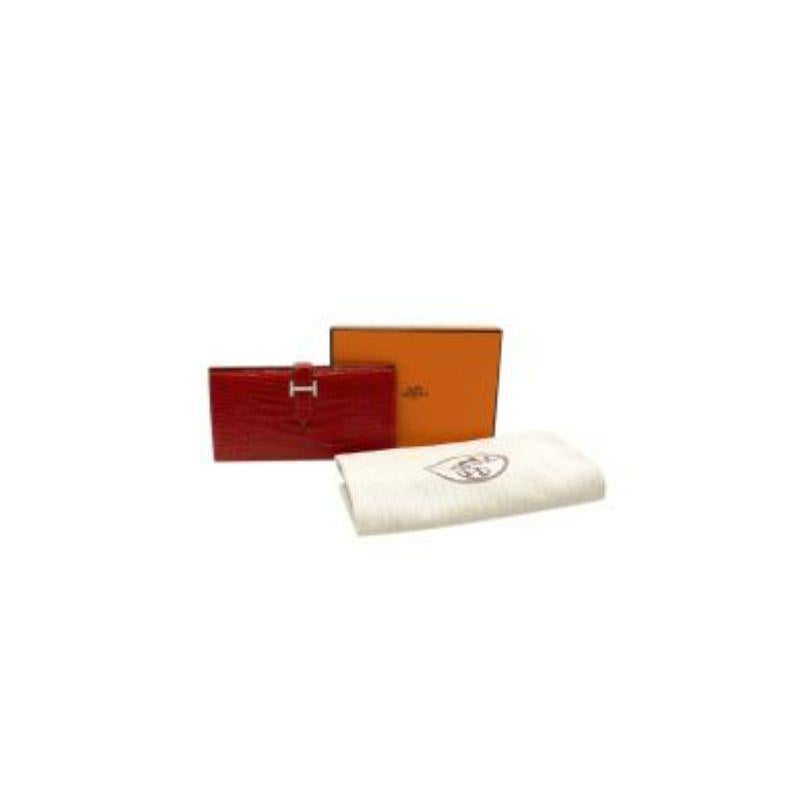 Hermes dark red Alligator pave diamond clasp long wallet
 
 Date code [J] 2006
 
 - Alligator Mississippiensis body in a rich, dark red hue
 - Bifold with flap fastening and H motif in palladium plating and pave white diamond 
 -Internal zip and