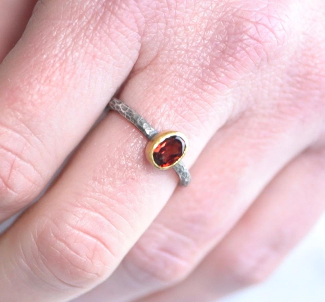 Dark Red, Oval, Garnet Solitaire Ring, 24kt Gold and Silver by Prehistoric Works of Istanbul, Turkey. Garnet - 1.00ct.  Band is slightly hammered and pairs well with stacking with other bands in the gallery. Size 7 US