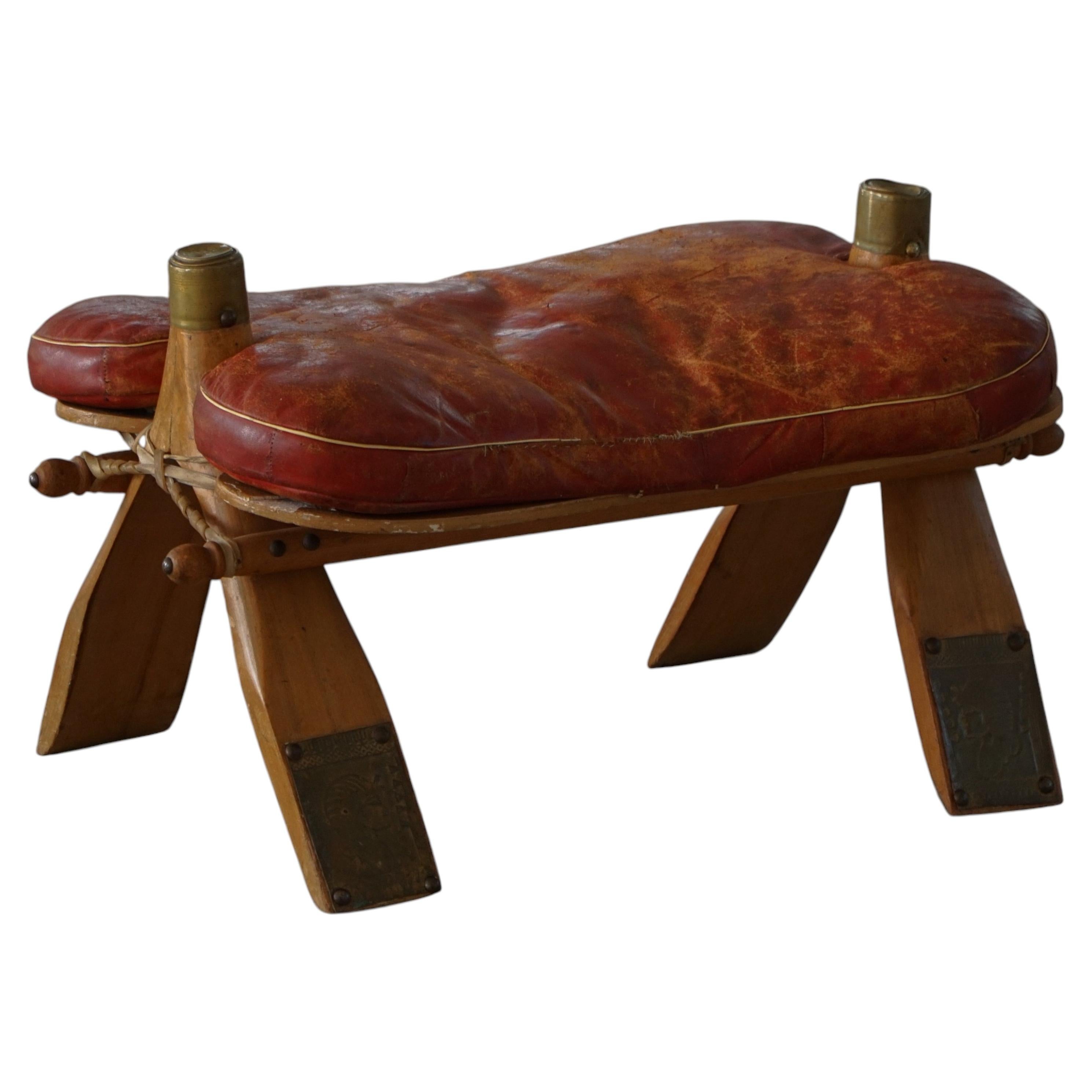 Dark Red Upholstered Moroccan Camel Saddle Footstool, 20th Century, North Africa