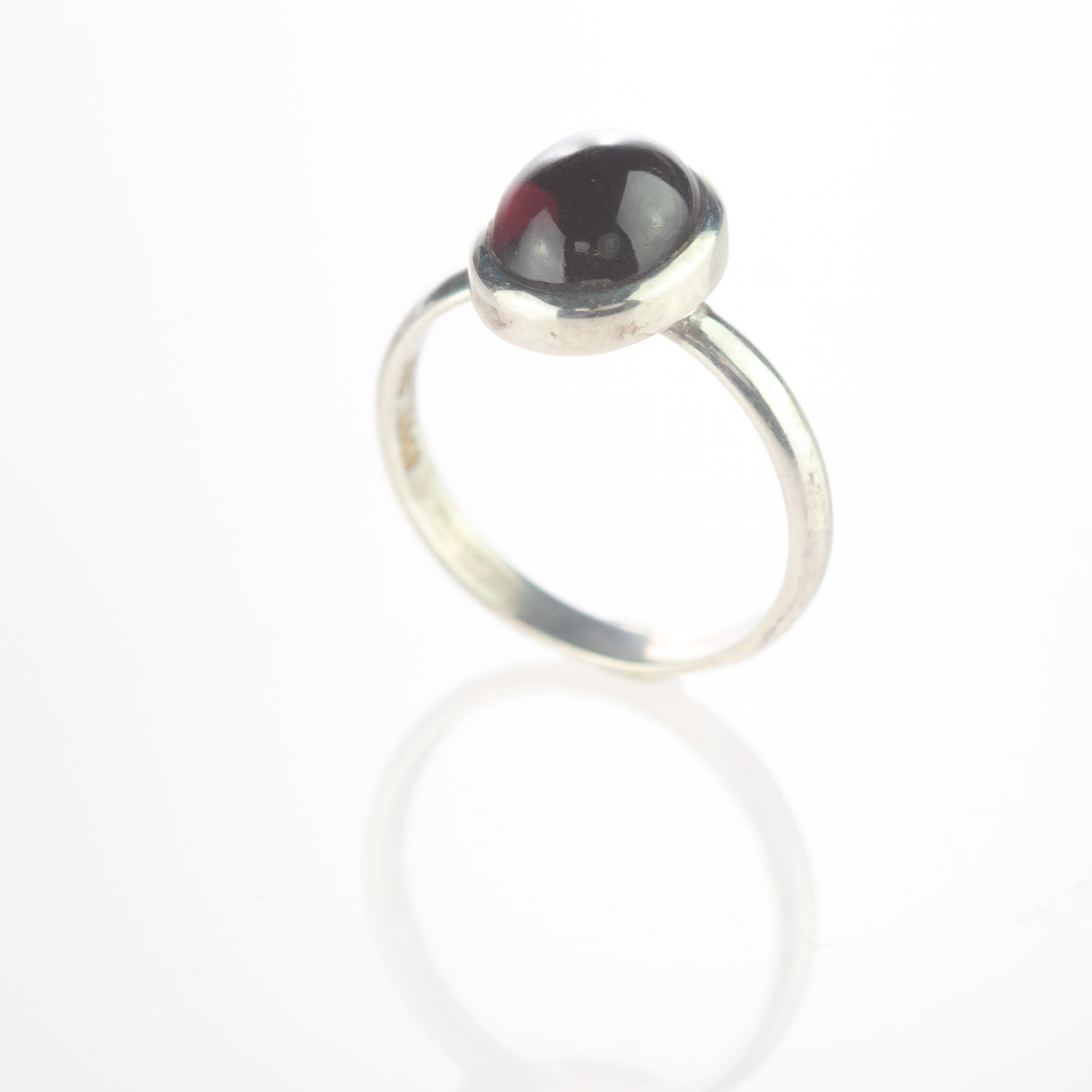 Dark red violet tourmaline ring with an oval cabochon design embellished in a sterling silver. This gem will fill your daily elegant outfits with a modern and simple design. The violet tourmaline ​​represents the stone of passion and intensity,