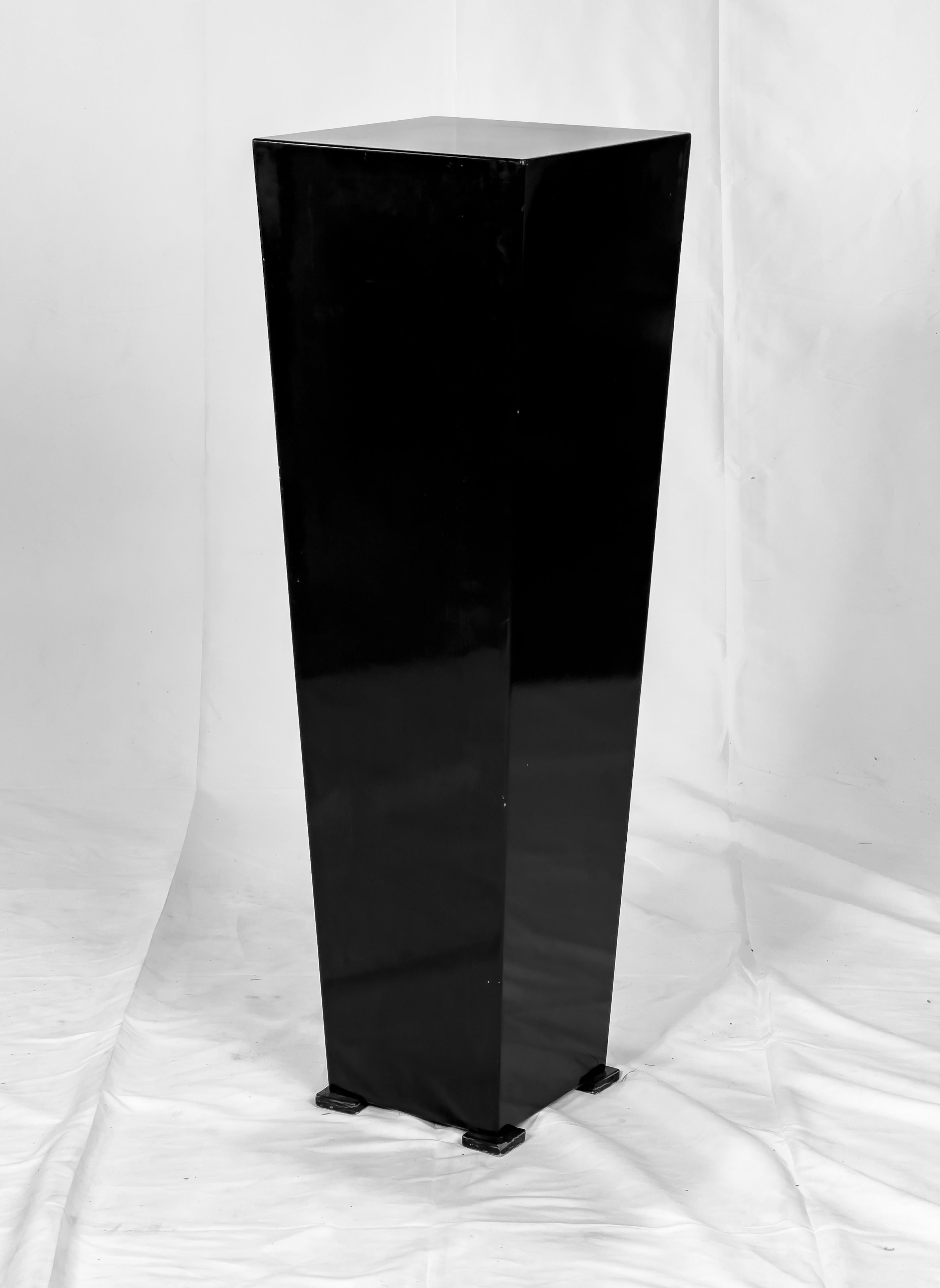 Dark Reflections a sculpture by Mac Whitney (b. 1936) a respected Texas artist most widely noted for his monumental sculptures. The piece is a black polished acrylic sculpture of an abstract form on a plinth base and signed with conjoined initials,