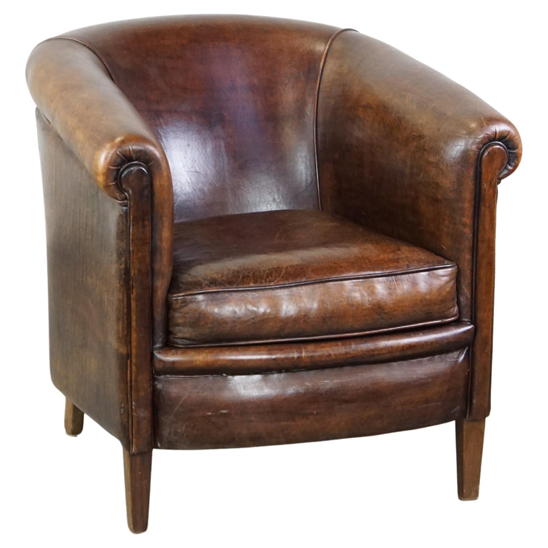 Dark, robust sheepskin club chair with beautiful appearance and correct seating