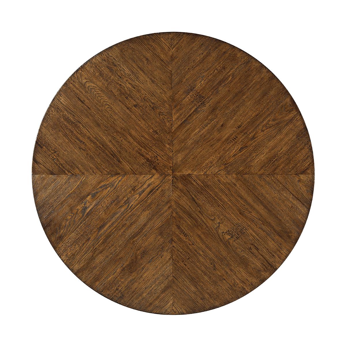 A modern rustic oak parquetry round dining table with tapered legs. The beautiful table has a radial design oak top with a flat truss and reinforcing oak stretcher. 
Shown in Dusk Finish
Dimensions: 48