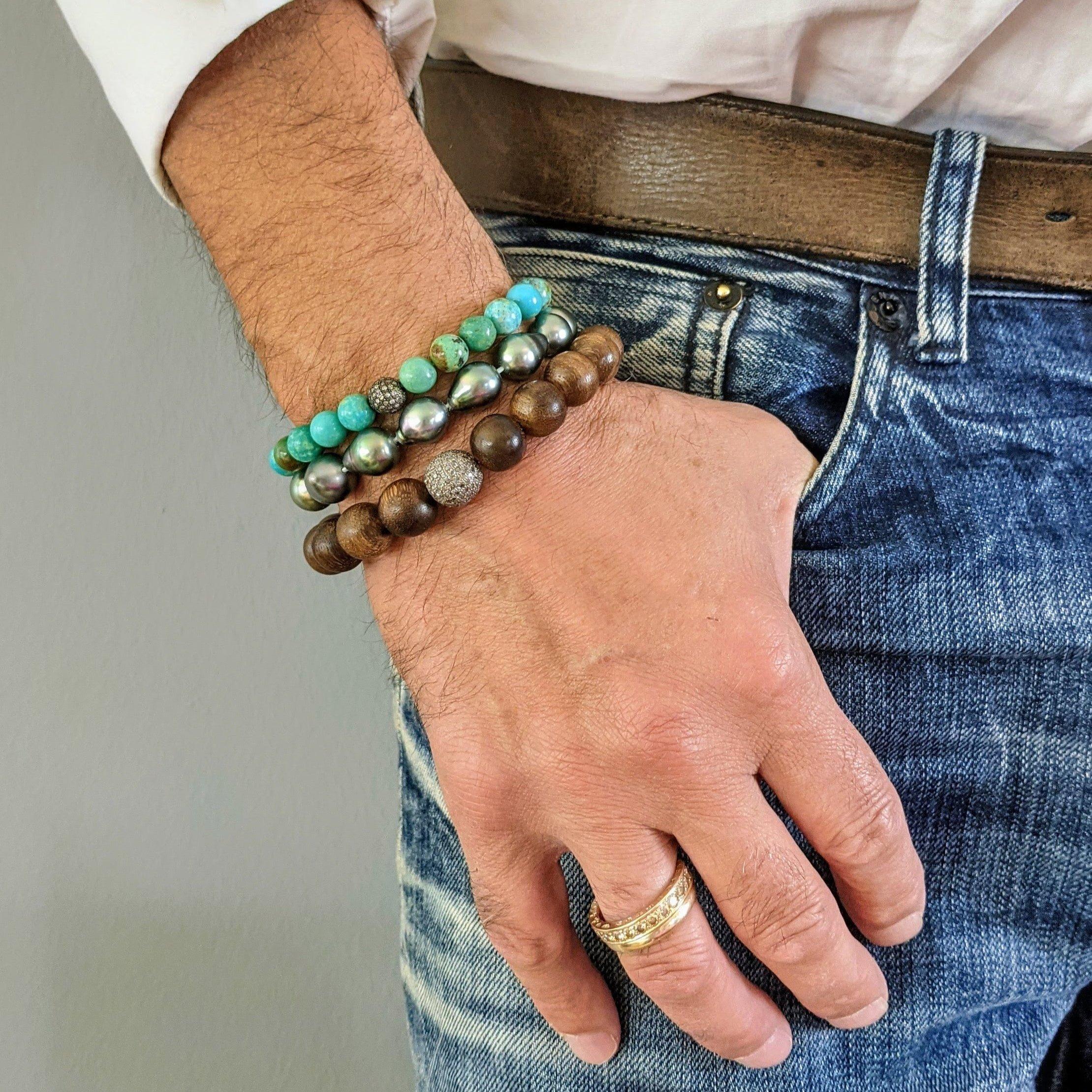The Amazon Diamond Bracelet is an exquisite piece, crafted from Amazon sandalwood beads with a 12 mm diameter, paired with a 1.6-carat silver diamond pavé that also measures 12 mm across. The craftsmanship features black-dyed silver adorned with