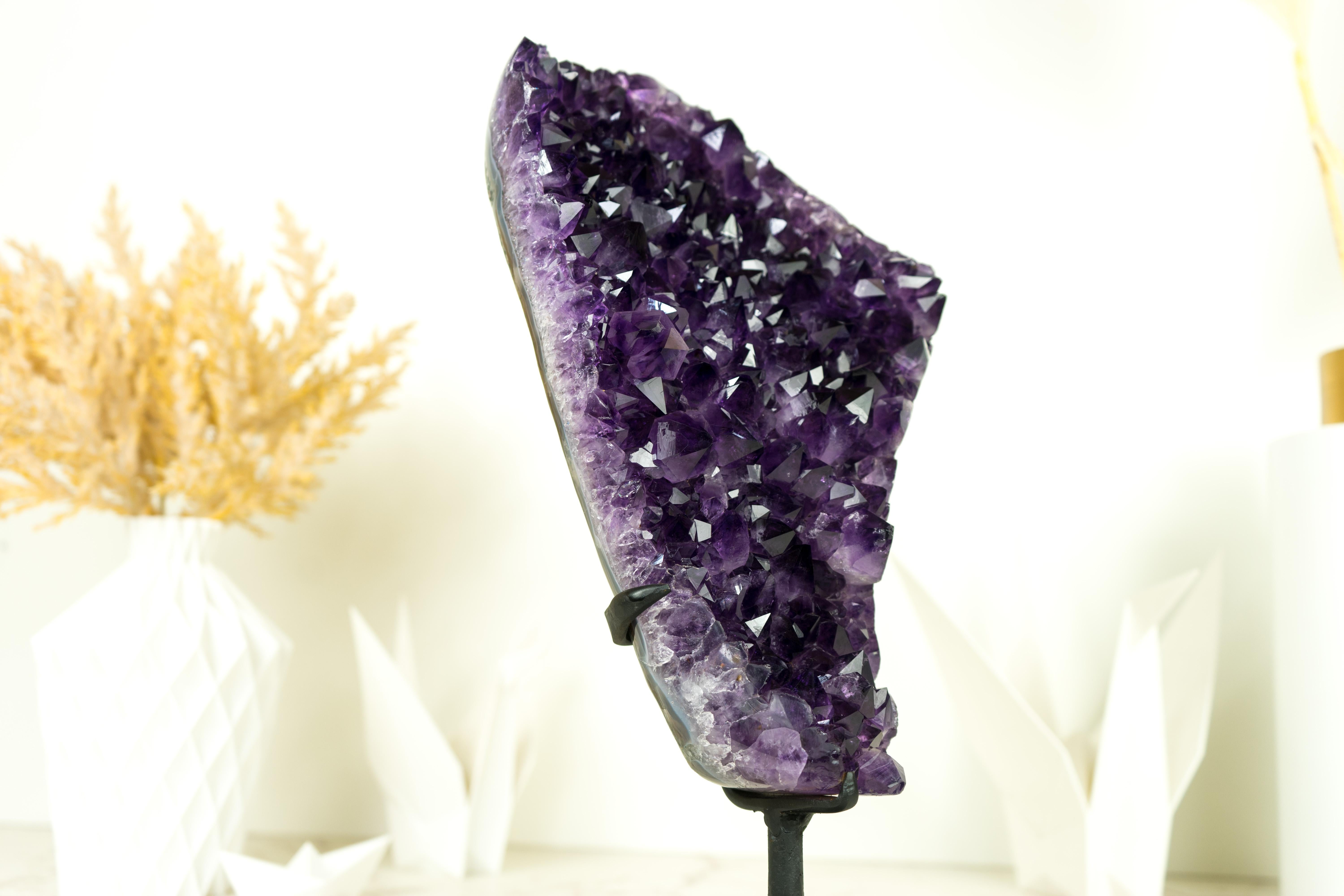 An extraordinary Amethyst Cluster that possesses world-class characteristics. Its deep, rich purple tone is the epitome of beauty and elegance, making it a standout centerpiece for any collection or home decor. This remarkable Amethyst radiates a