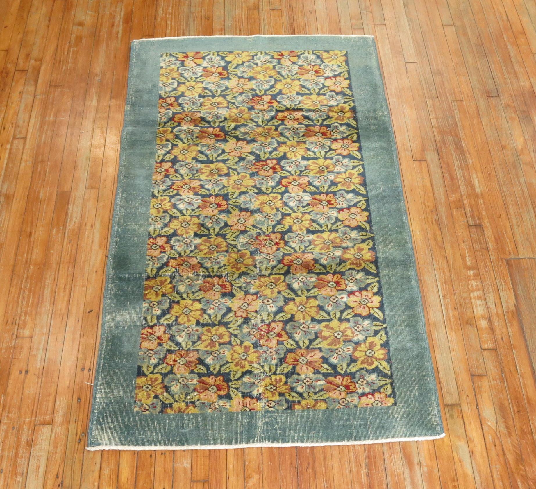For the shabby chic buyer, this midcentury one of a kind Turkish rug with an all-over floral motif encased by a sea foam dark blue green border. 

Measures: 3'11