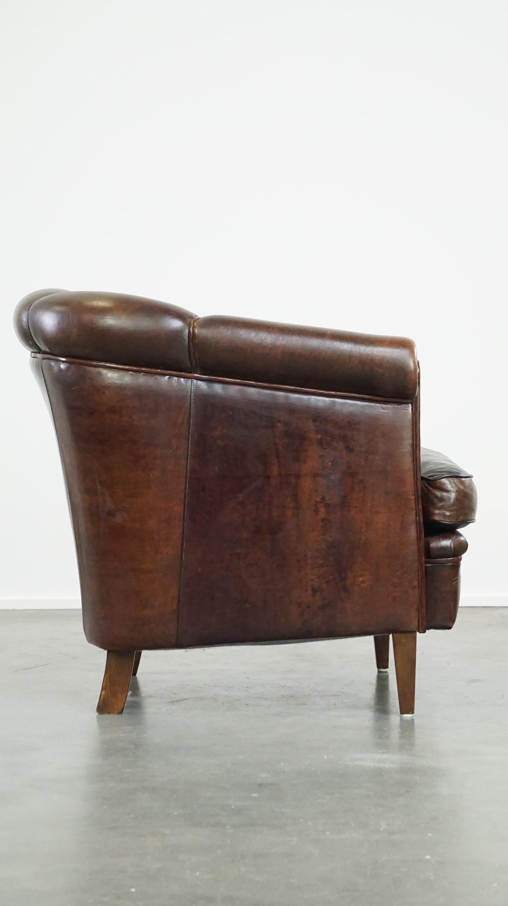 Hand-Crafted Dark sheep leather club chair with uniquely shaped armrests For Sale