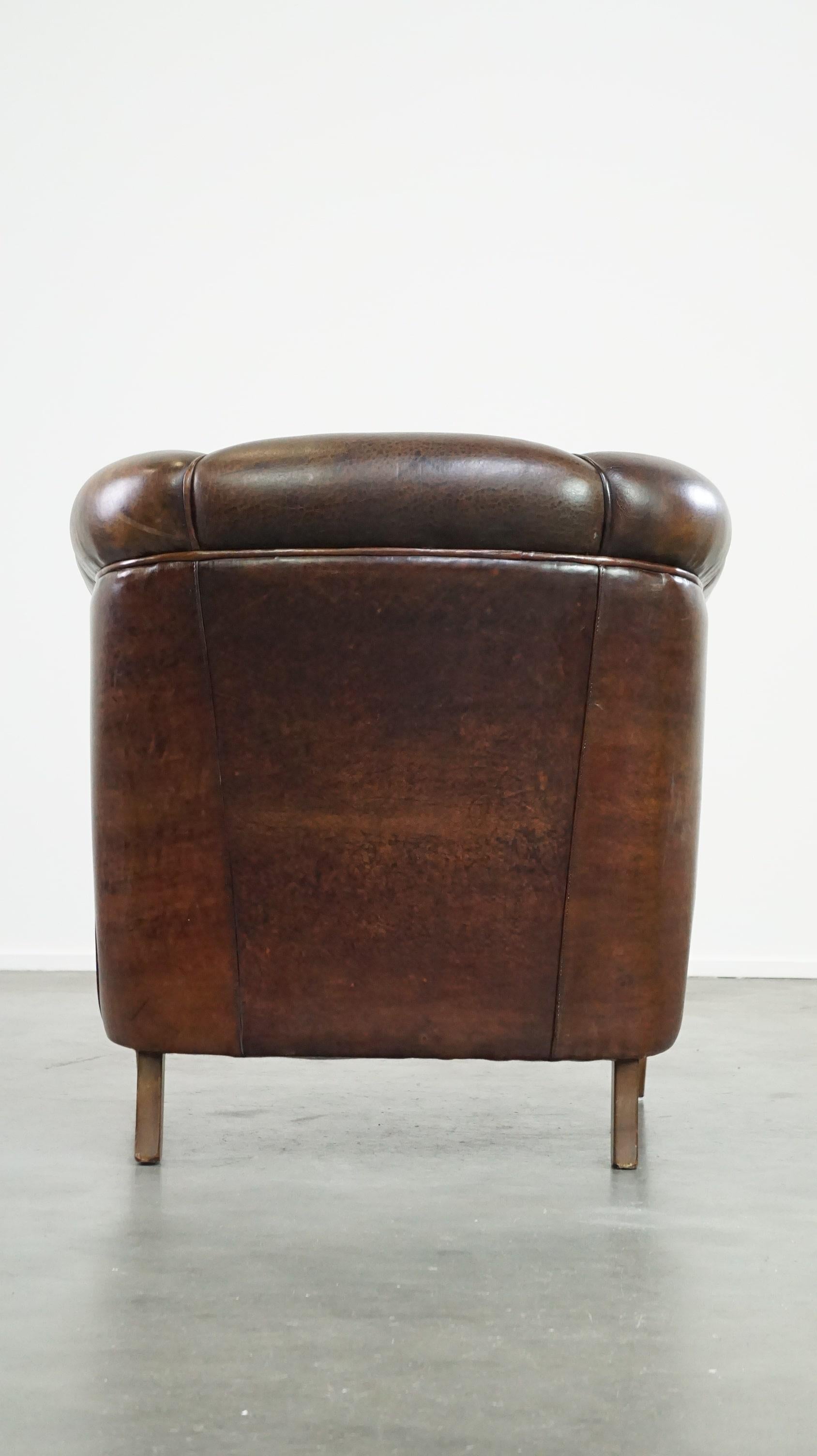 Dark sheep leather club chair with uniquely shaped armrests In Good Condition For Sale In Harderwijk, NL