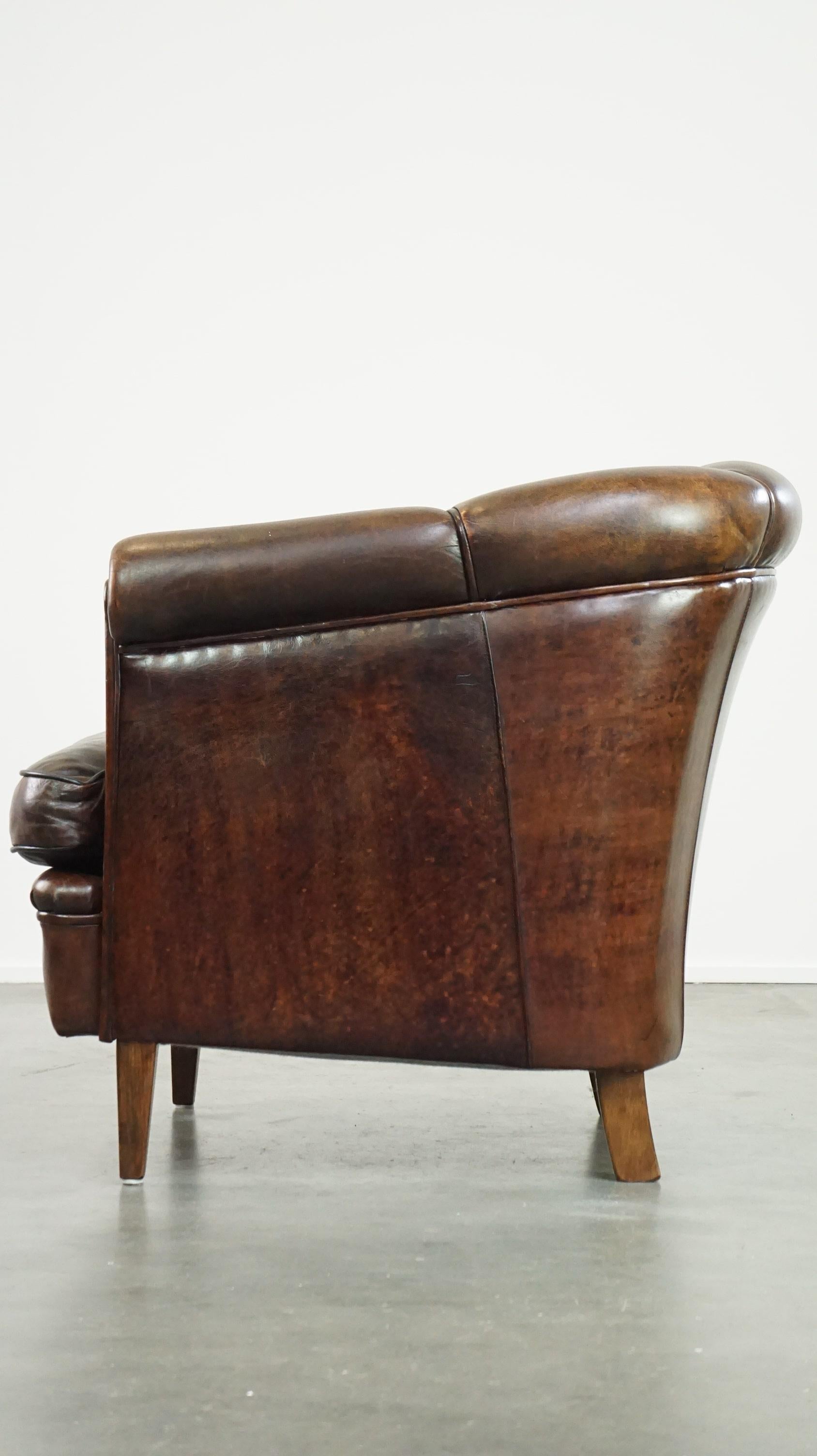 20th Century Dark sheep leather club chair with uniquely shaped armrests For Sale