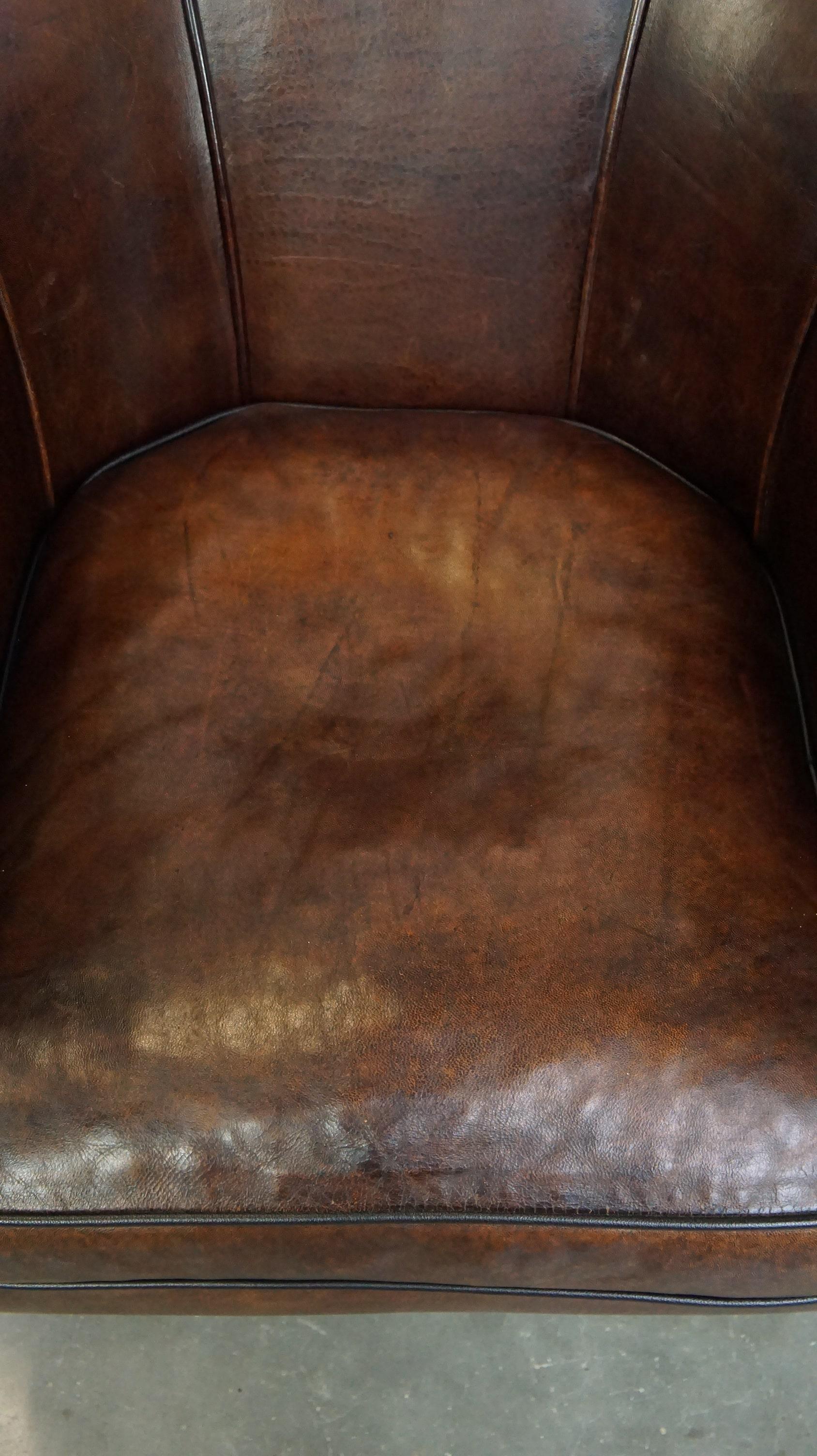 Sheepskin Dark sheep leather club chair with uniquely shaped armrests For Sale