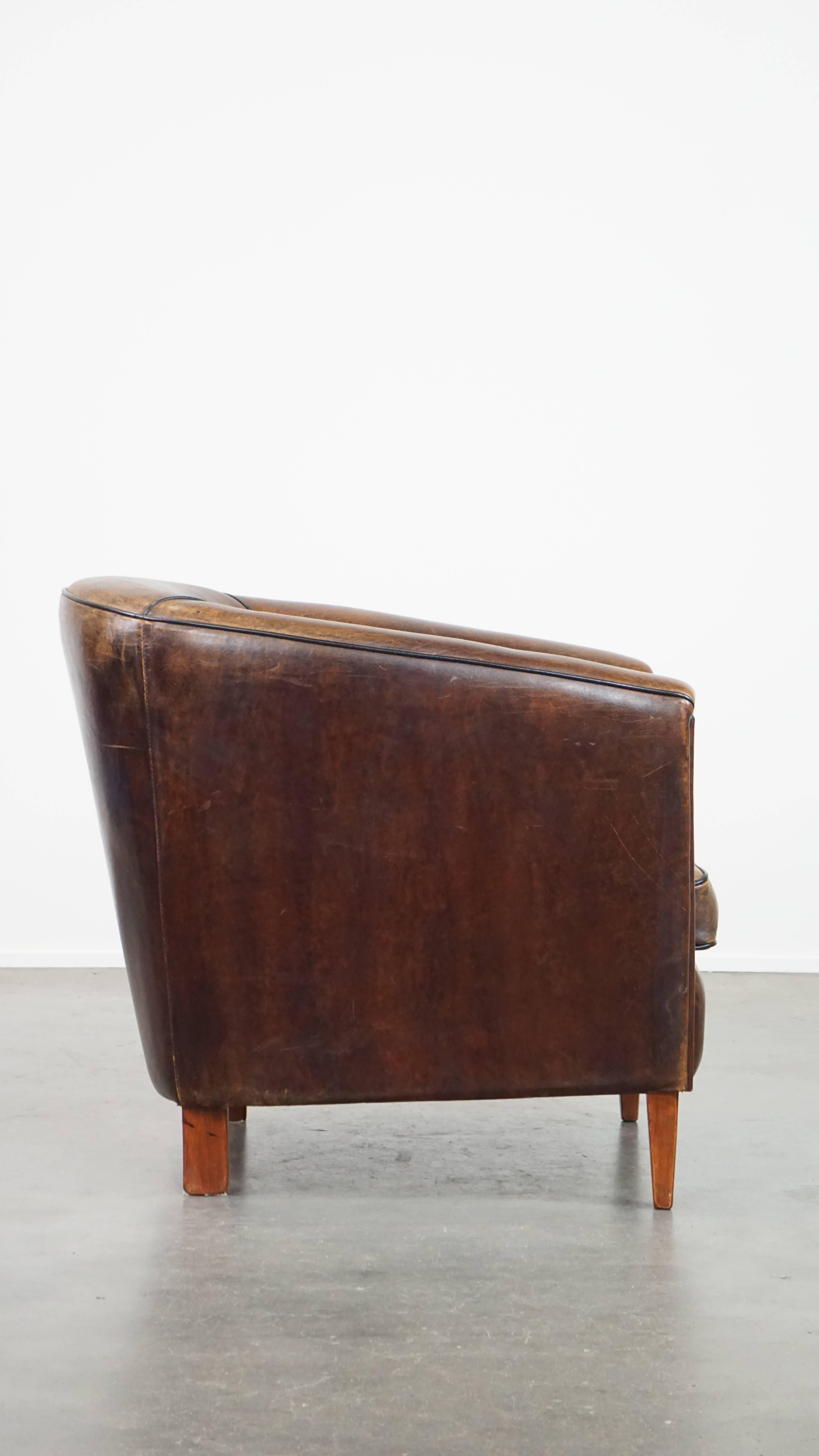 Hand-Crafted Dark, sleek, luxurious sheepskin leather club armchair with beautiful colors For Sale