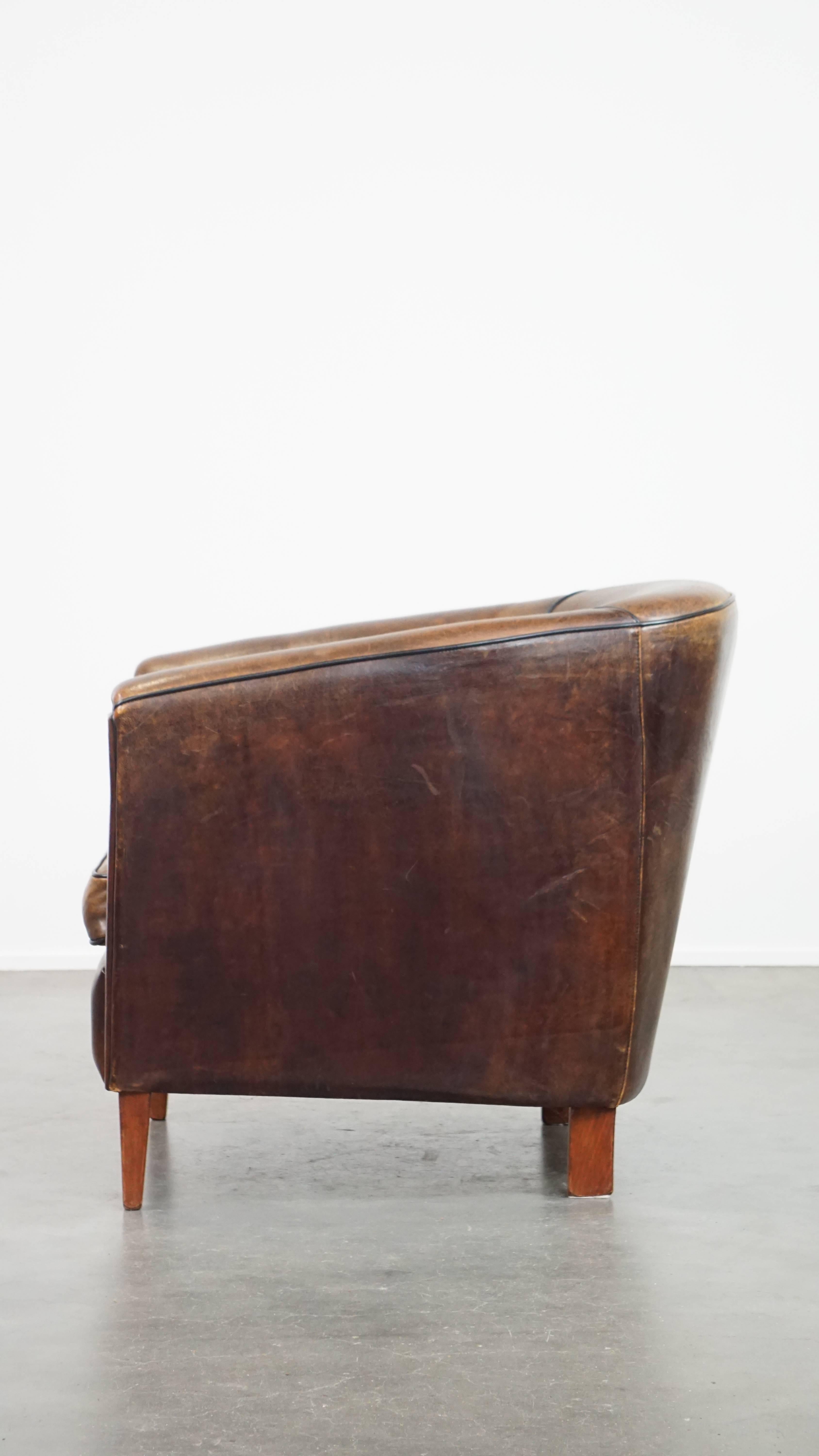 20th Century Dark, sleek, luxurious sheepskin leather club armchair with beautiful colors For Sale