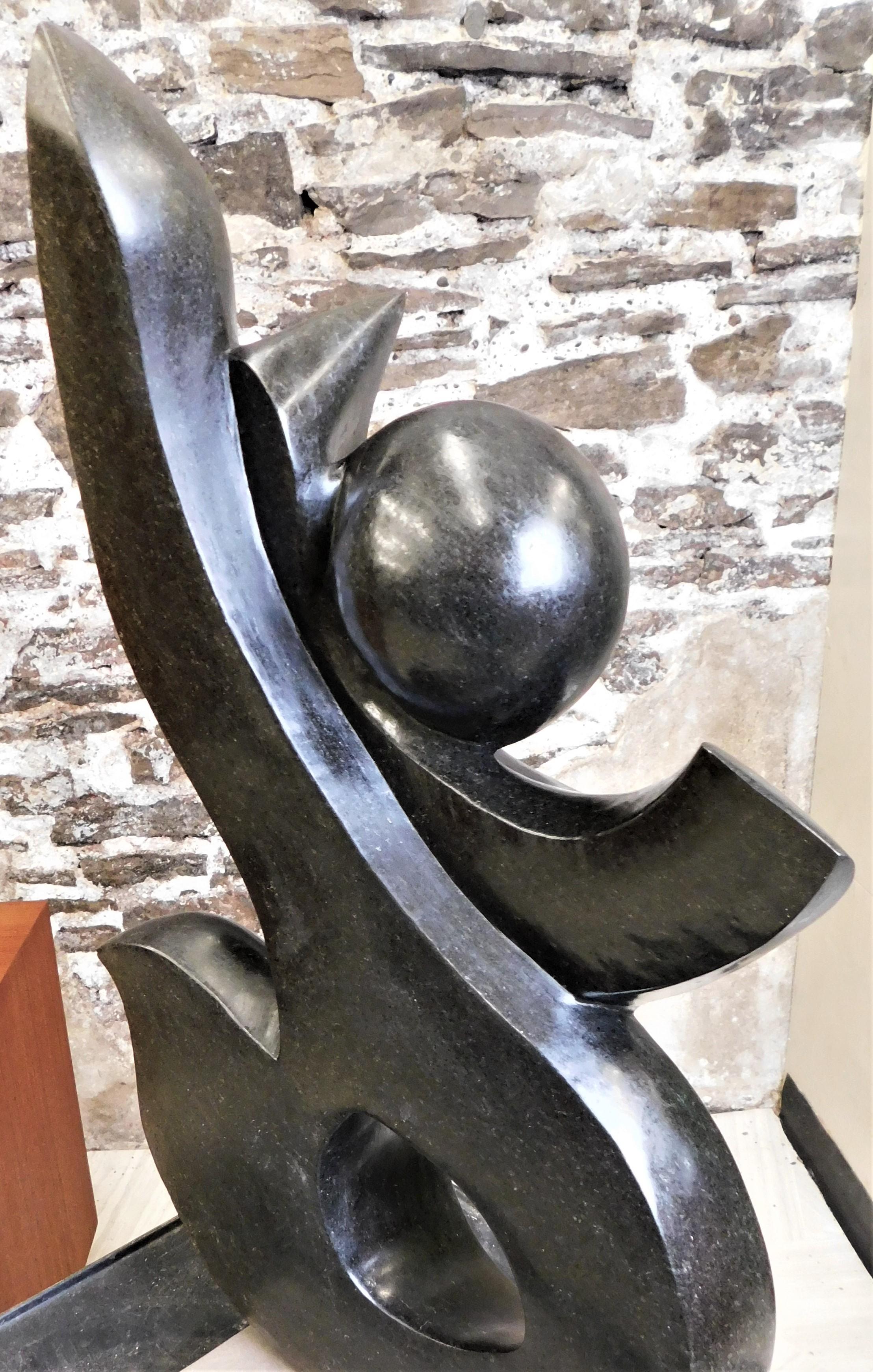 Hand-Carved Dark Stone Abstract Art Sculpture on Base