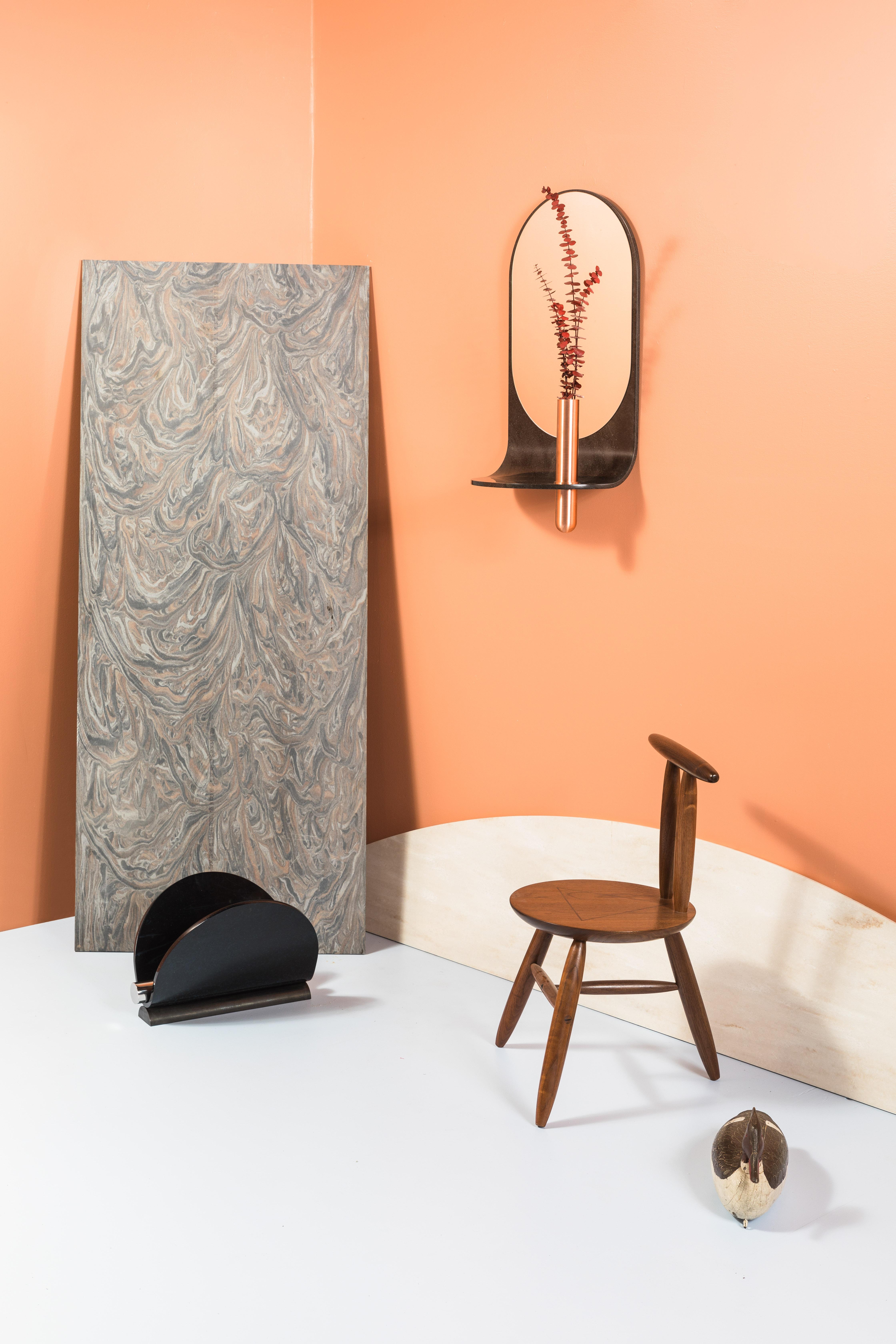 Flats, rounds, mirrored geometries, and streamlined profiles define the Swoop Mirror. Made from thermoformed artificial stone and bronze and crafted my hand. Perfect for entryways or hall areas, it gracefully integrates a storage shelf, a vase, and