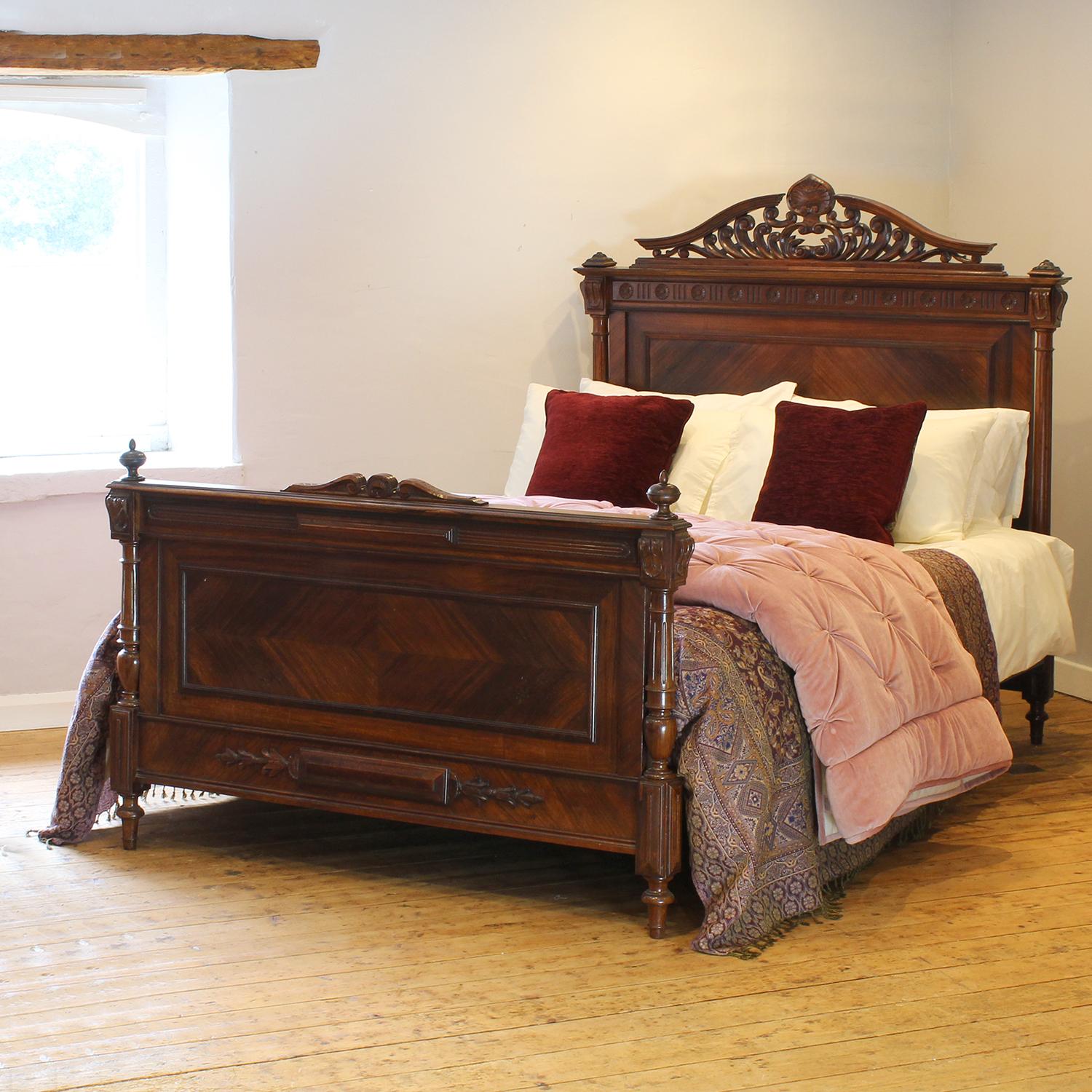 A fabulous style bedstead in dark walnut with decoratively carved pediment and turned posts.

This bed accepts a British king size or American queen size, 5ft wide (60 inches or 150cm) base and mattress set.

The price includes a deep firm bed