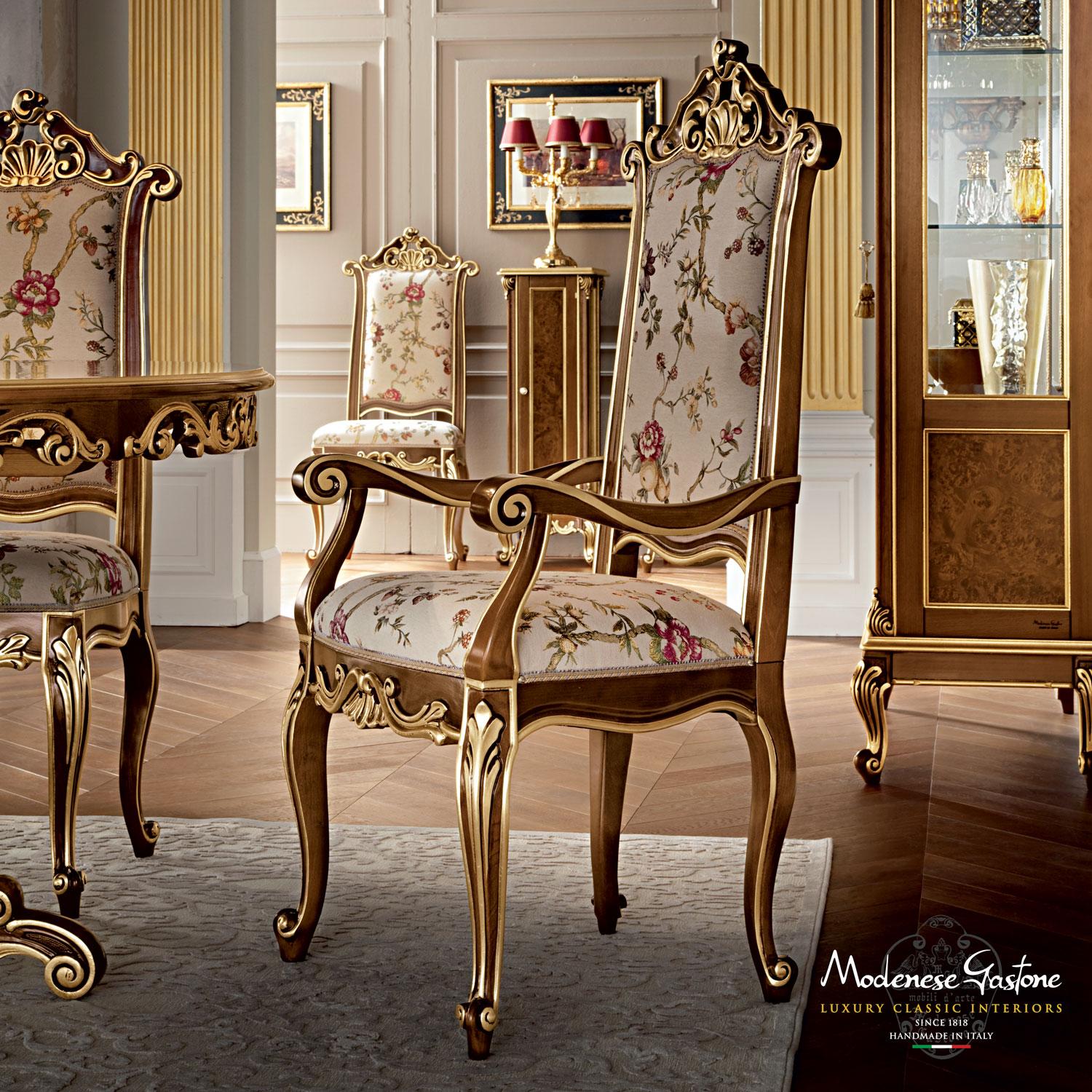 High-end palaces need high-end furniture, and the mission of Modenese Gastone Interiors is to serve this purpose. This majestic shiny dining chair presents a dark wlanut finish with gold leaf applications along the carved lines, while the seating