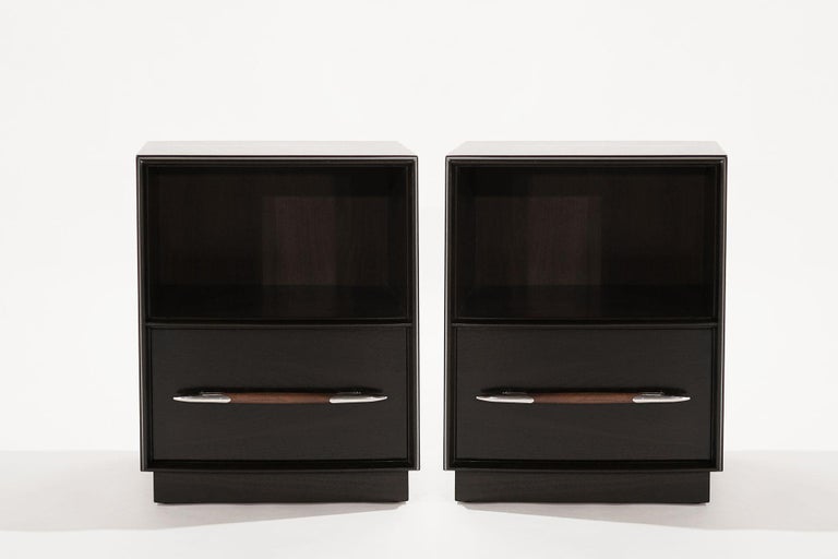 Set of nightstands designed by T.H. Robsjohn-Gibbings for Widdicomb, circa 1950-1959. Executed in walnut, completely restored in our dark walnut finish, featuring contrasting natural walnut wood handles and nickel hardware.
 
Other designers from