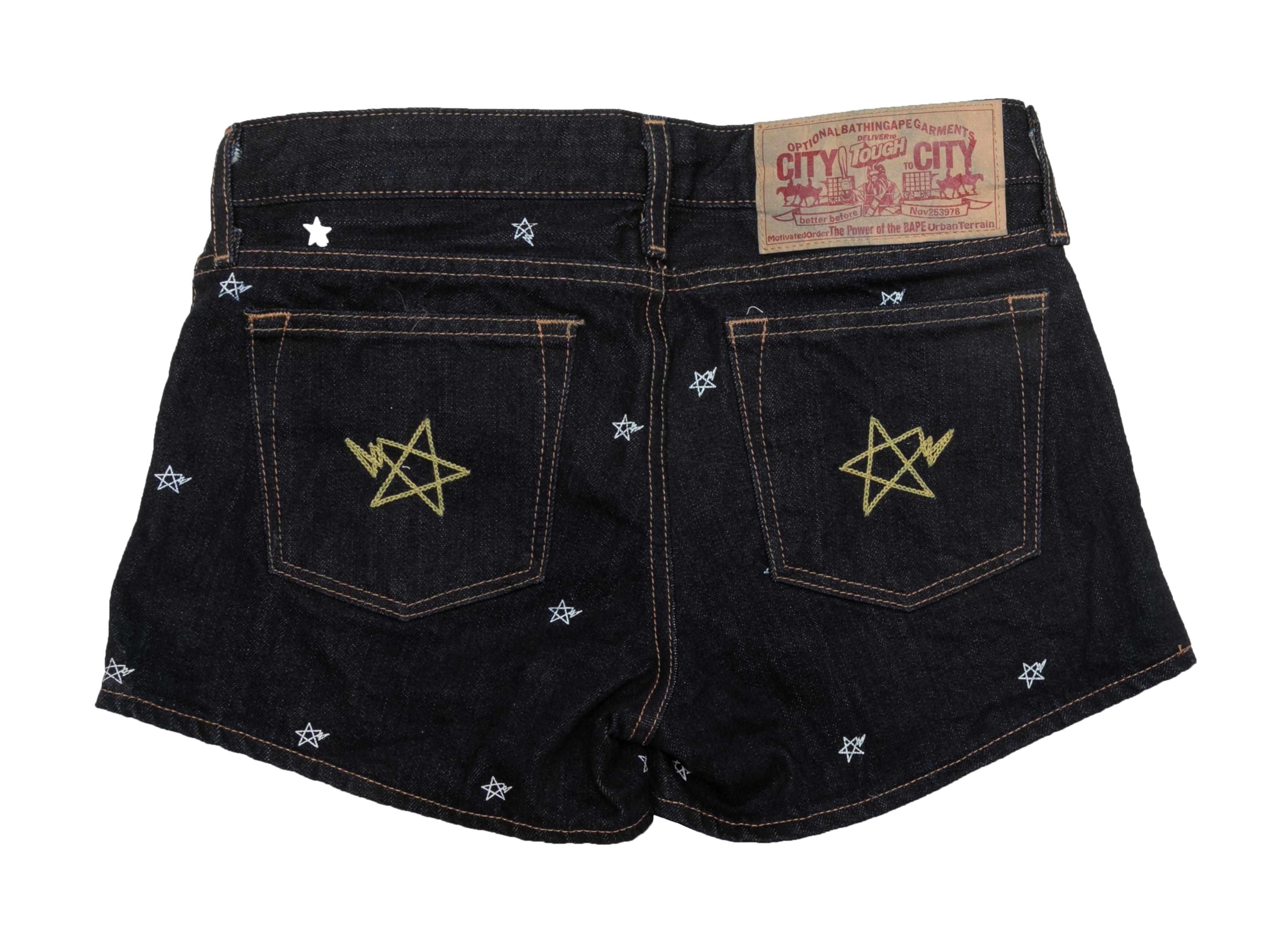 Dark wash embroidered star denim mini shorts by BAPE. Contrast stitching throughout. Five pockets. Zip and button closures at front. 28