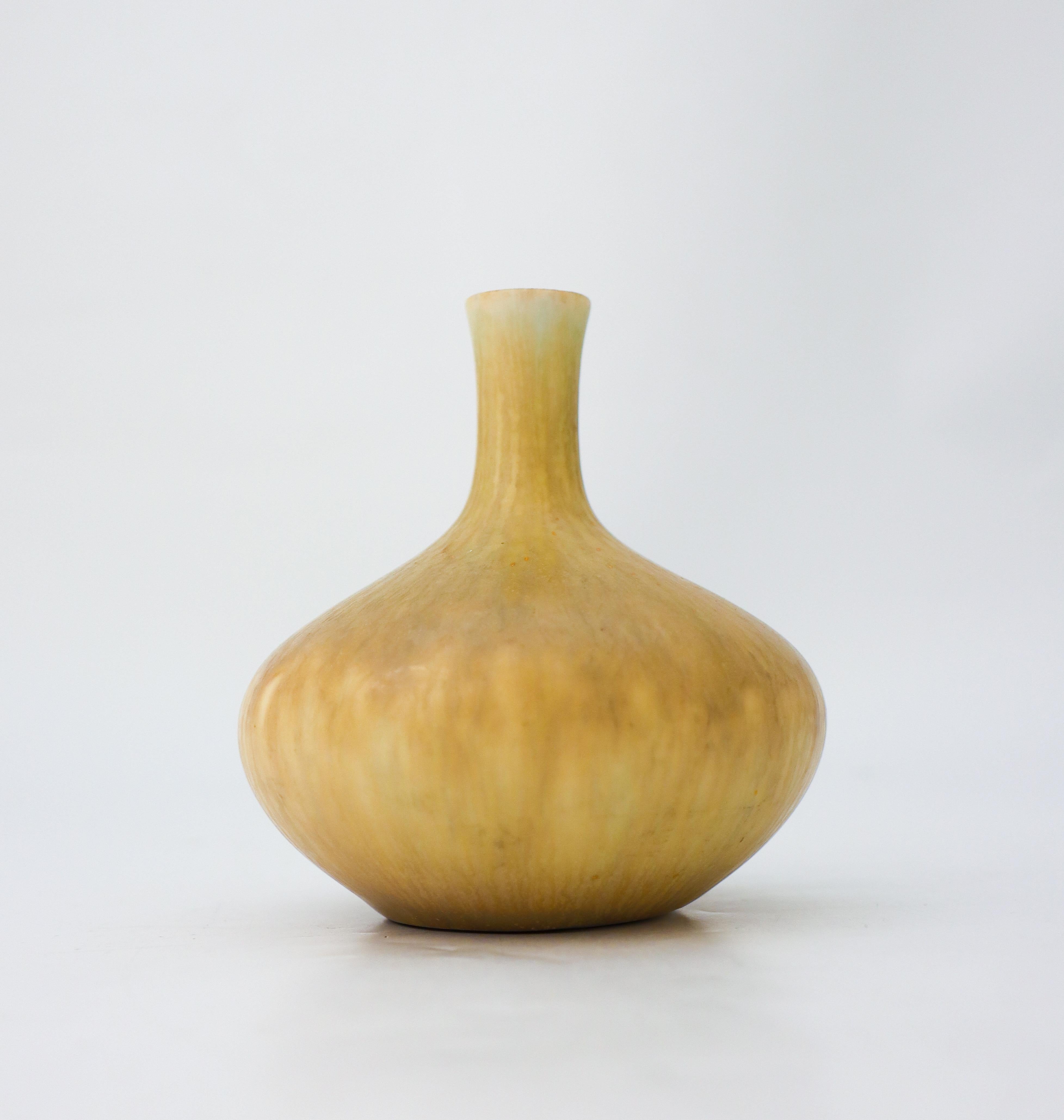 A dark yellow vase designed by Carl-Harry Stålhane at Rörstrand. The vase is 10.5 cm (4.2