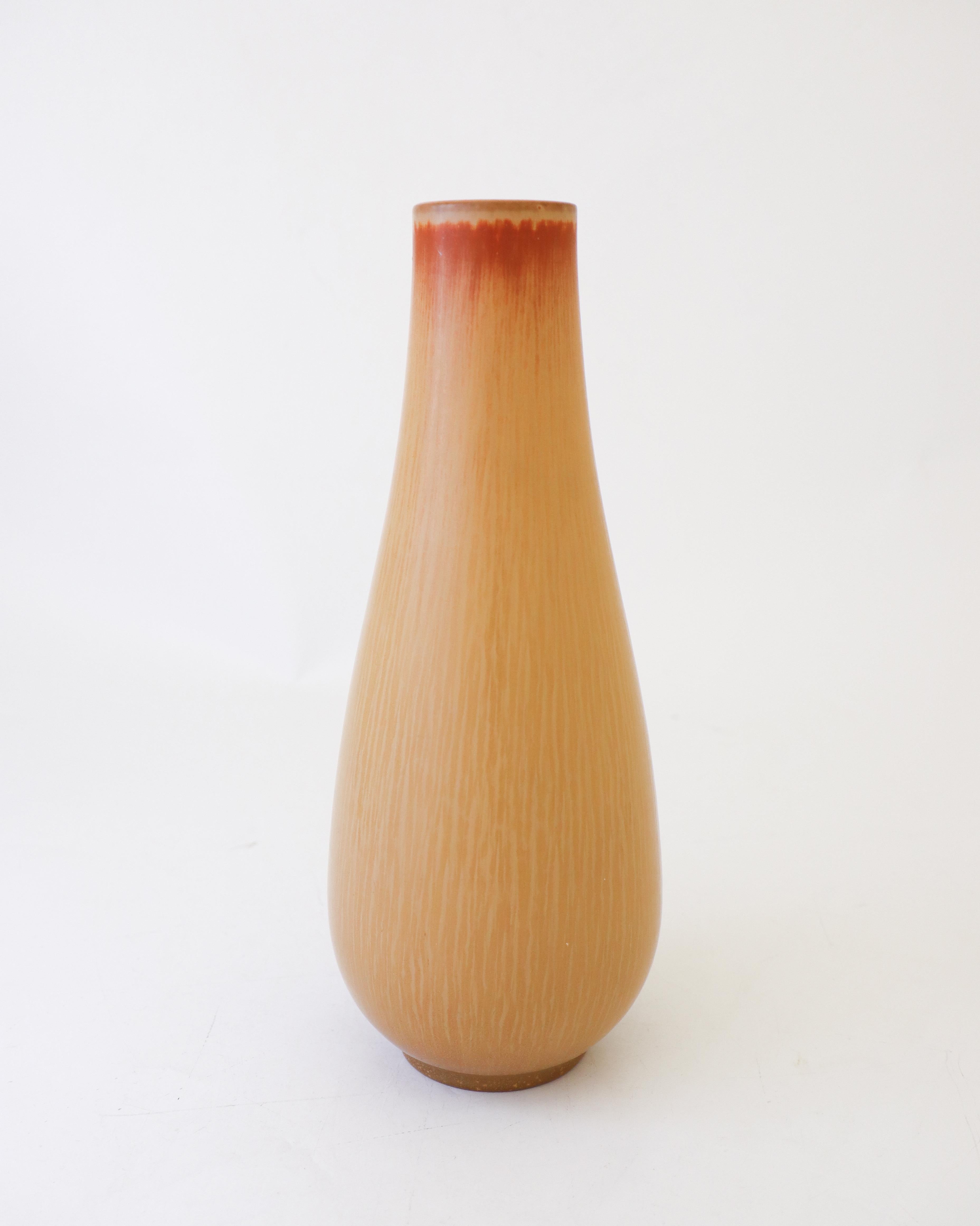 Un joli vase jaune foncé conçu par Gunnar Nylund chez Rörstrand, le vase mesure 27,5 cm (11