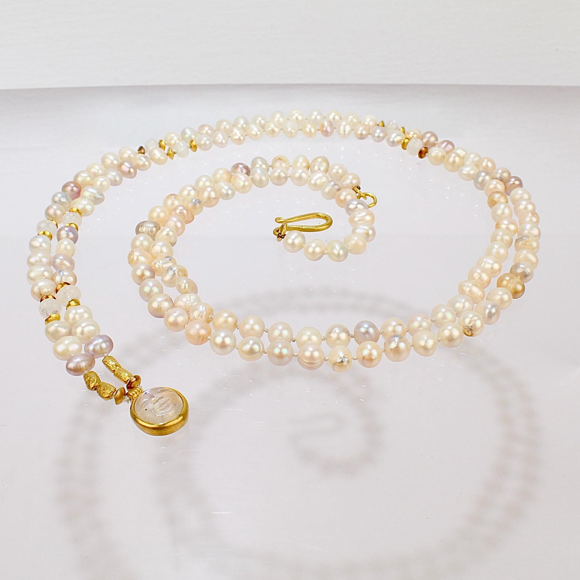 A very fine high karat gold, pearl and moonstone necklace by Darlene de Sedle.

The necklace consists of colored and white hand knotted pearls, 22 karat gold findings and beads, and several moonstone beads as well as a carved moonstone cabochon