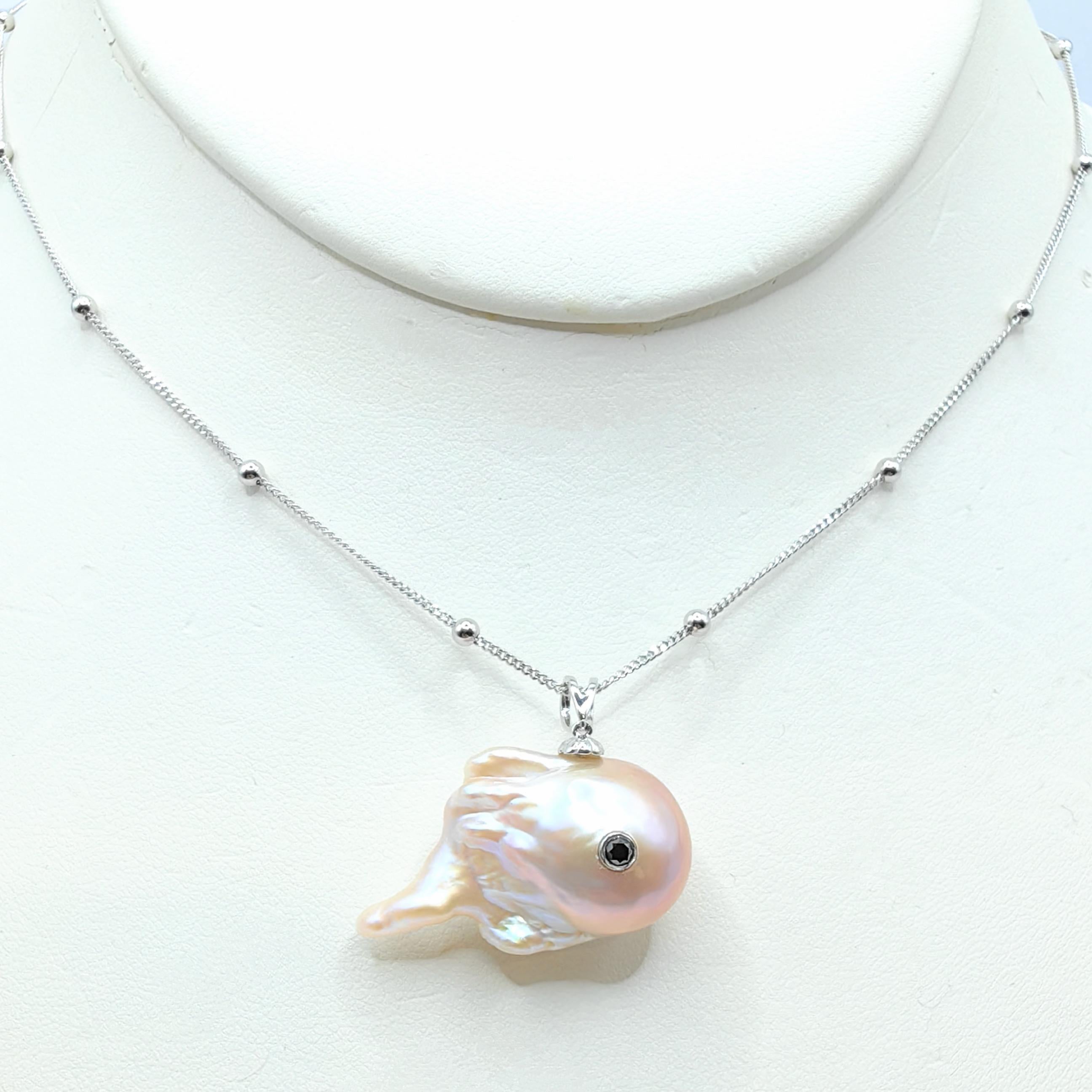 Dive into the mystical realm of ethereal charm with the captivating Darling Dragon Spirit: Black Diamond & Pink Baroque Pearl 18K White Gold Pendant. Crafted from a luminous freshwater baroque pearl, this enchanting pendant embodies the essence of