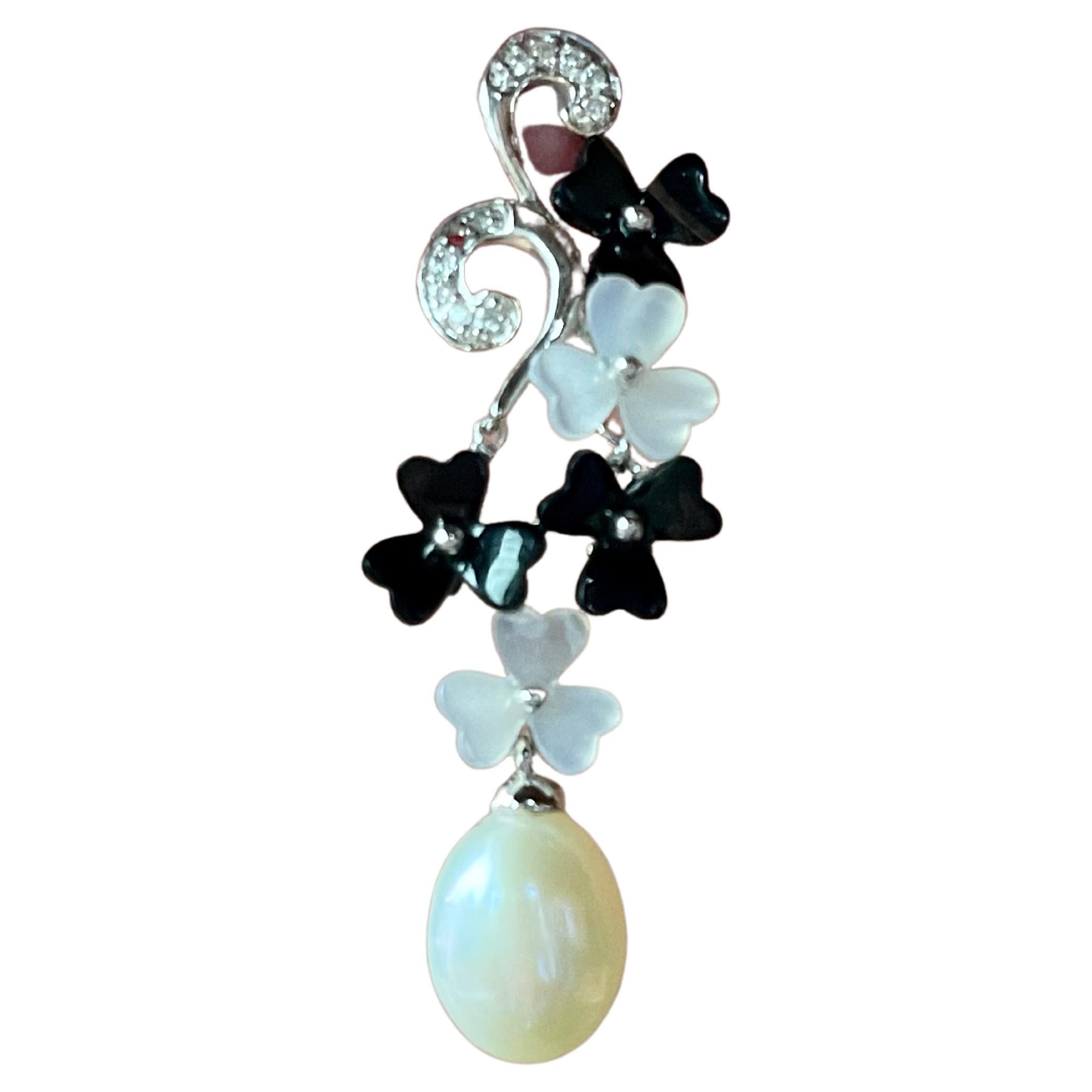 Lovely dangle earrings in 18 K white Gold featuring 2 freshwater cultured Pearls, carved flowers in Onyx and Mother of Pearl and tiny Diamonds. Length: 4.3 cm. 
Masterfully handcrafted piece! Authenticity and money back is guaranteed. 
For any
