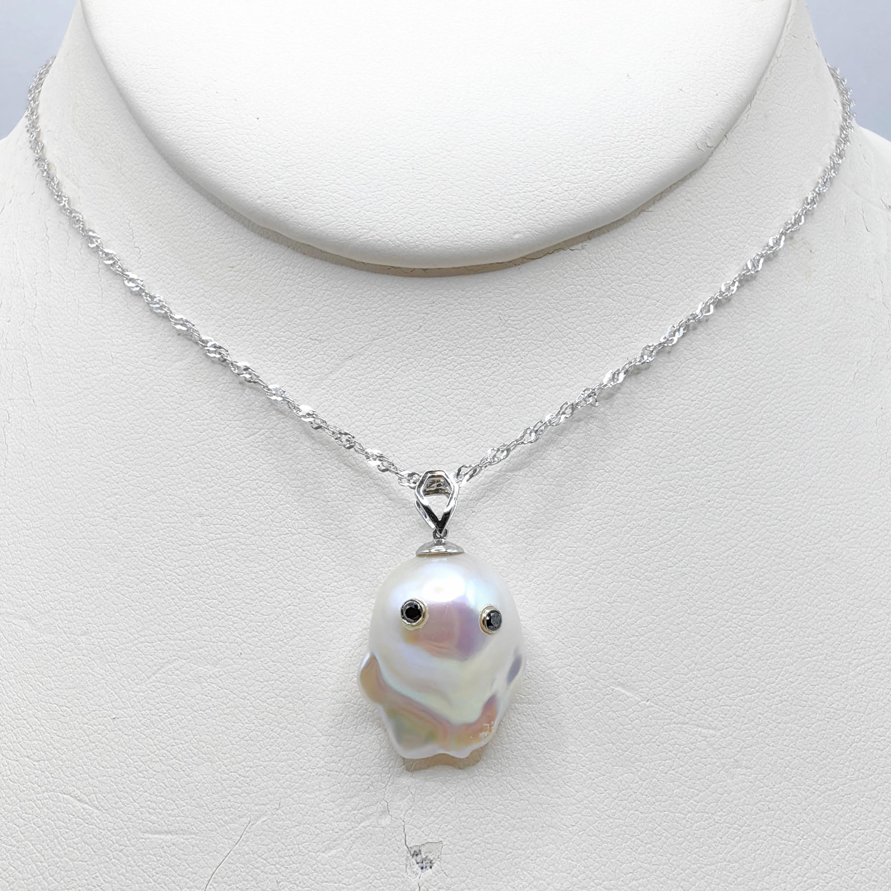 Unveil the enchanting Darling Phantom: a whimsical marvel featuring a Black Diamond accented Baroque Pearl set in 18K White Gold, evoking the spirit of a friendly ghost. This adorable piece, with a pendant length of approximately 1.10 inches, is