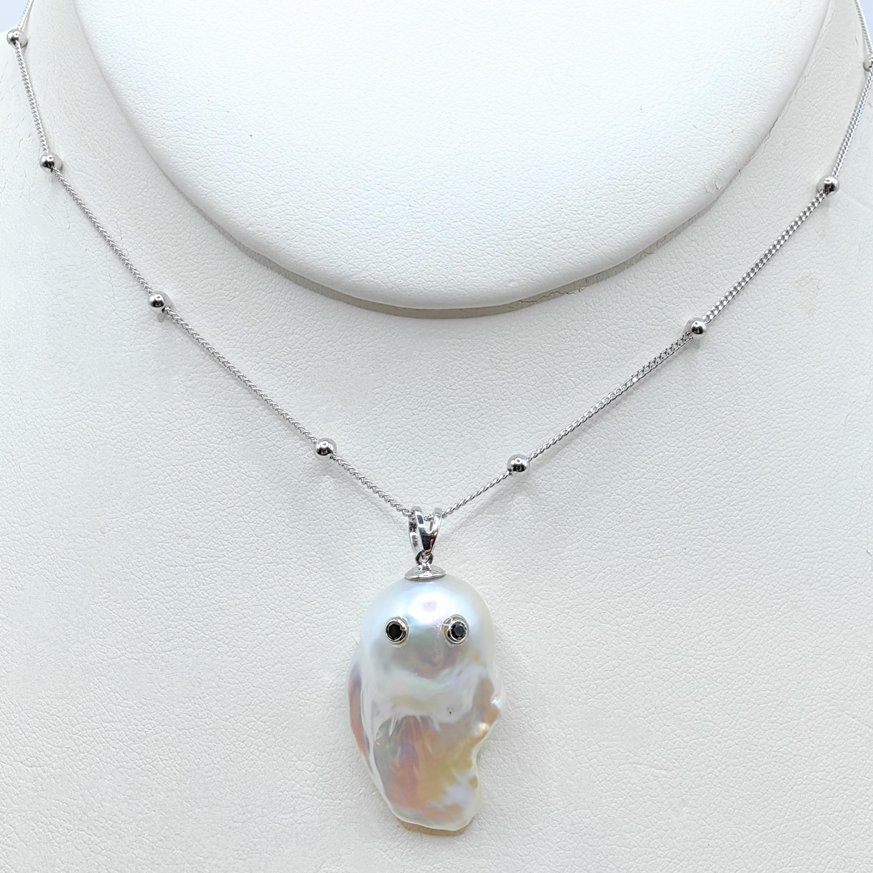Unveil the enchanting Darling Phantom: a whimsical marvel featuring a Black Diamond accented Baroque Pearl set in 18K White Gold, evoking the spirit of a friendly ghost. This adorable piece, with a pendant length of approximately 1.35 inches