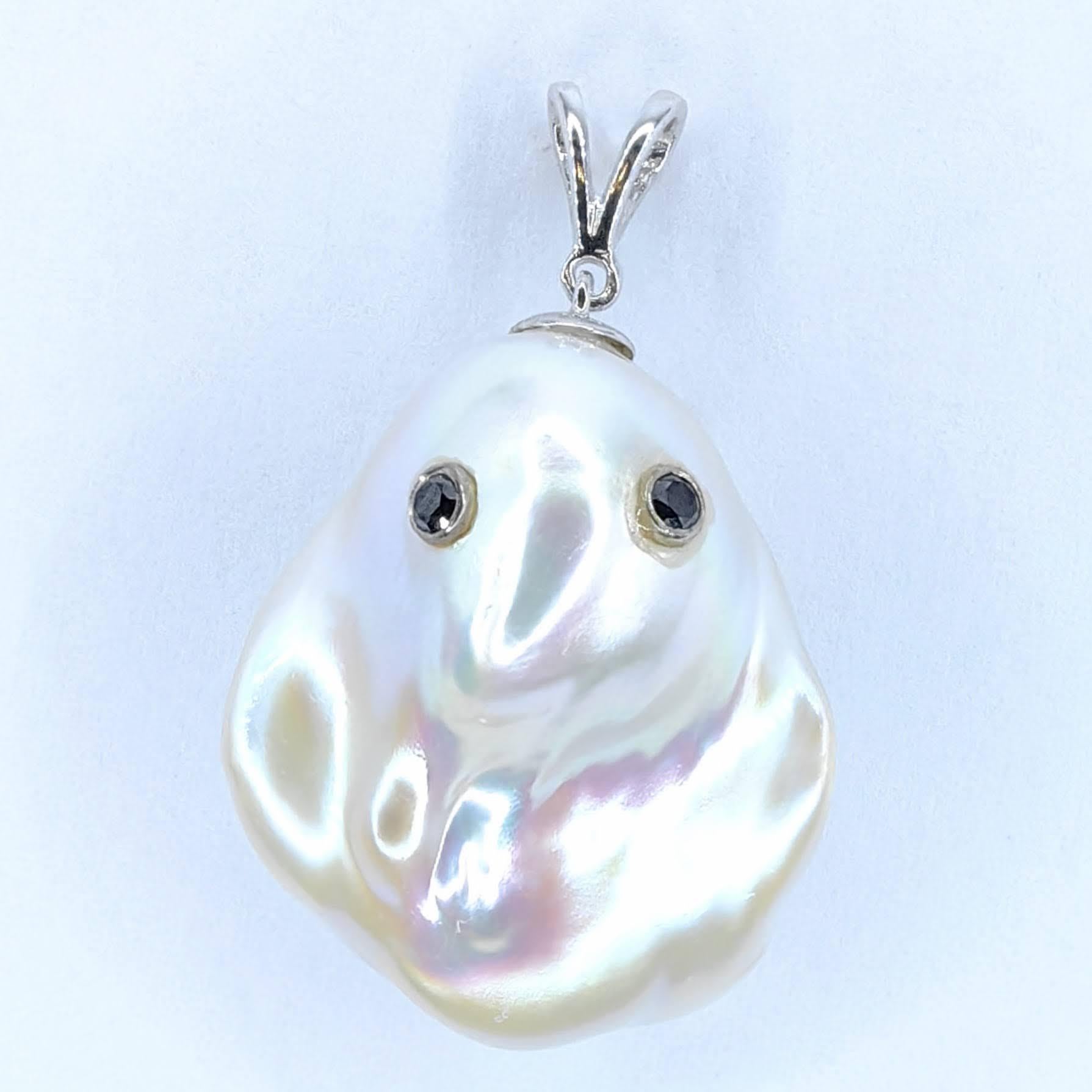 Unveil the enchanting Darling Phantom: a whimsical marvel featuring a Black Diamond accented Baroque Pearl set in 18K White Gold, evoking the spirit of a friendly ghost. This adorable piece, with a pendant length of approximately 1.31 inches (3.35