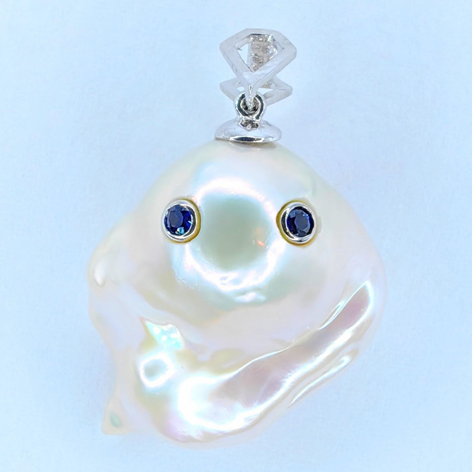 Unveil the enchanting Darling Phantom: Blue Sapphire White Baroque Pearl Ghost Pendant 18K White Gold, evoking the spirit of a mischievous yet charming ghost. This captivating piece, with a pendant length of approximately 1 inch (3 cm), is perfect