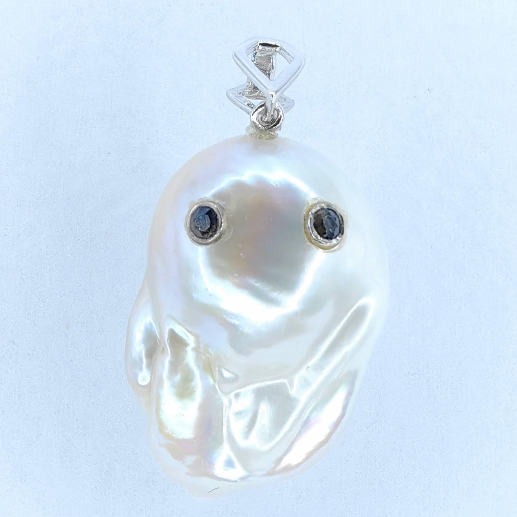 Unveil the enchanting Darling Phantom: Blue Sapphire White Baroque Pearl Ghost Pendant 18K White Gold, evoking the spirit of a mischievous yet charming ghost. This captivating piece, with a pendant length of approximately 1.21 inch (3.08 cm), is